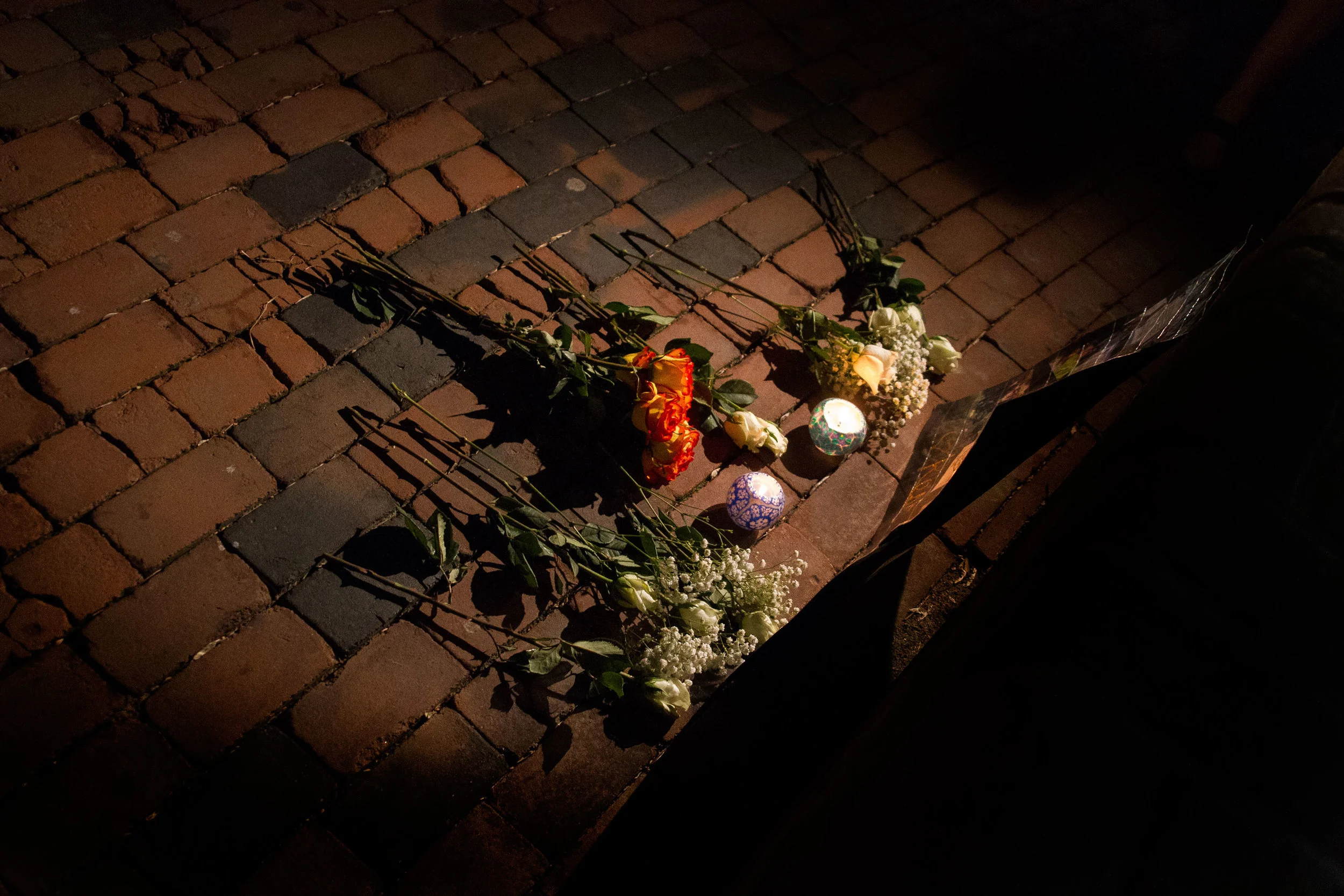 A small memorial is left at the front of a candlelight vigil for two Towson University students who died on March 31, 2012 in separate incidents.
