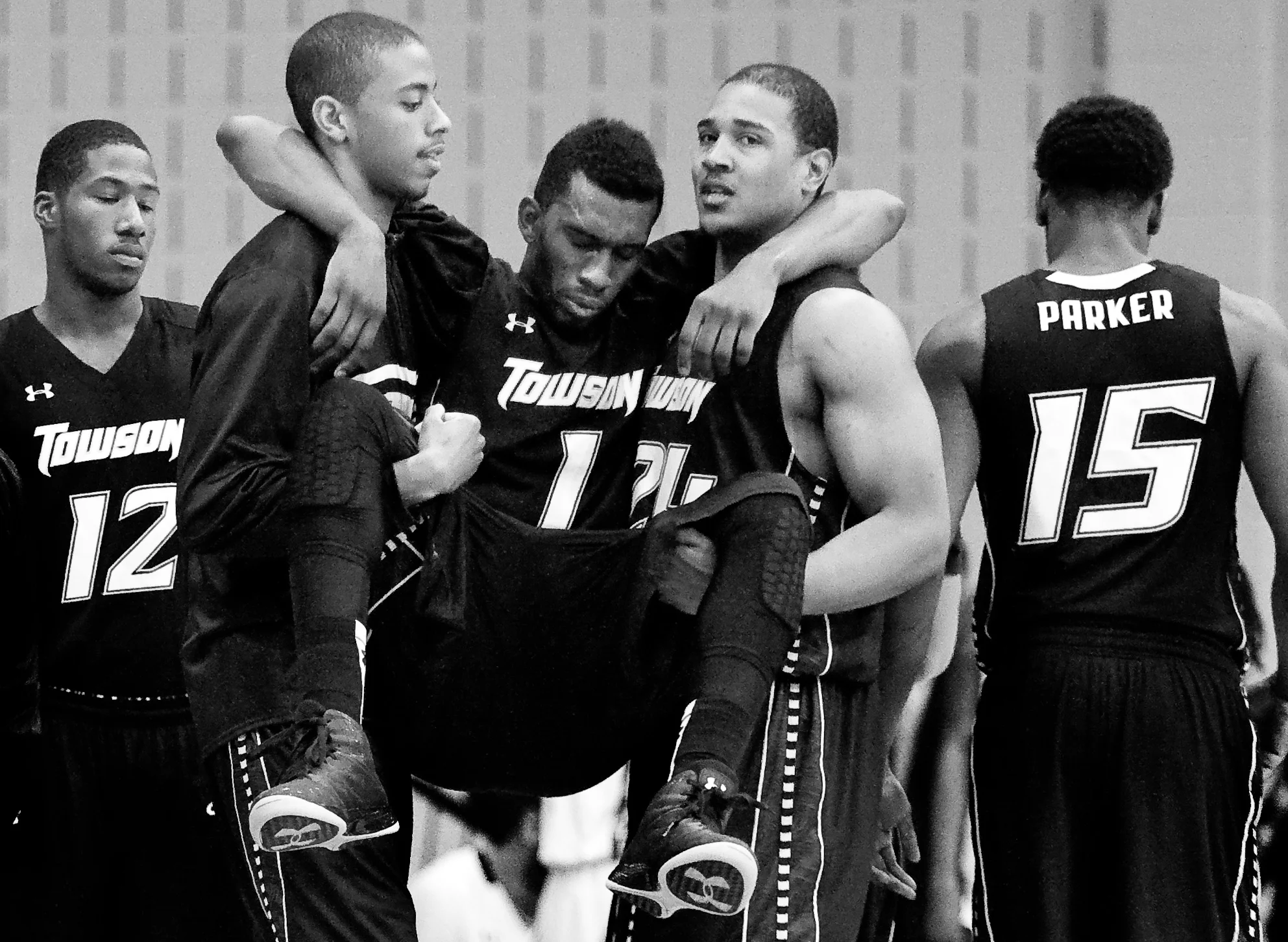 Towson University forward Marcus Damas is carried off the court after being injured during a game at Loyola University on Nov. 26, 2012 in Baltimore, Md. 