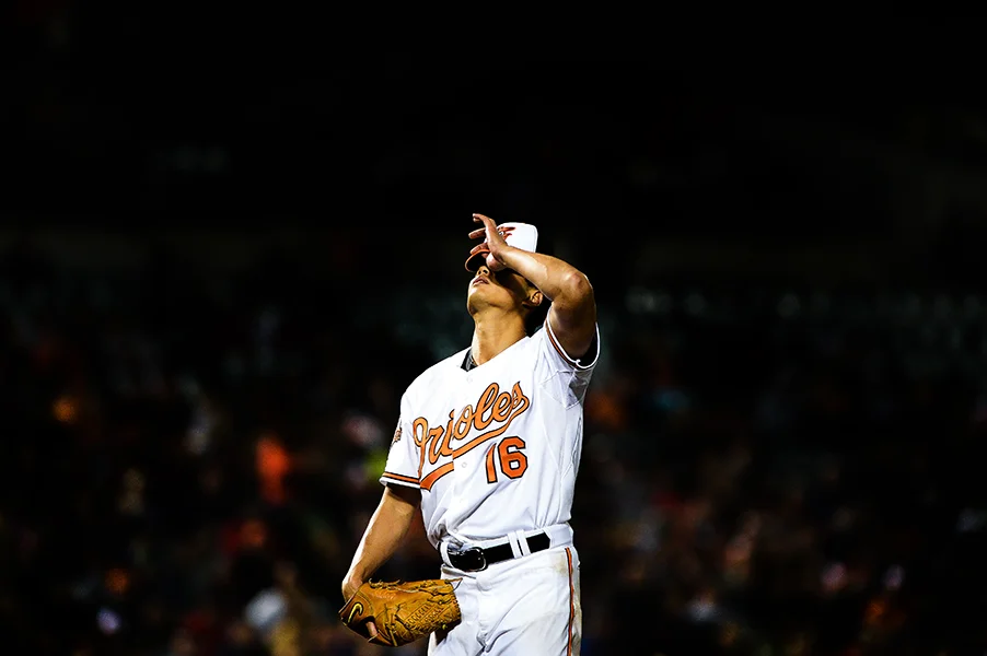 Baltimore Orioles pitcher Wei-Yin Chen adjusts his hat during a game against the Boston Red Sox on April 3, 2014 at Oriole Park in Camden Yards in Baltimore, Md.