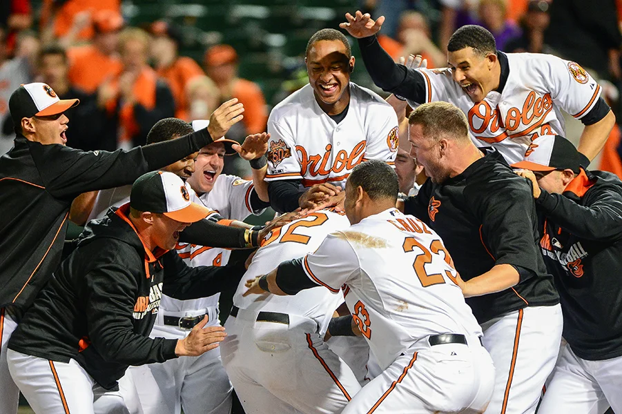 Baltimore Orioles' Matt Wieters is swarmed by his teammates at home plate after hitting the walk-off home run to beat the Pittsburgh Pirates in the 10th inning at Oriole Park at Camden Yards in Baltimore, Maryland on May 1, 2014&nbsp;