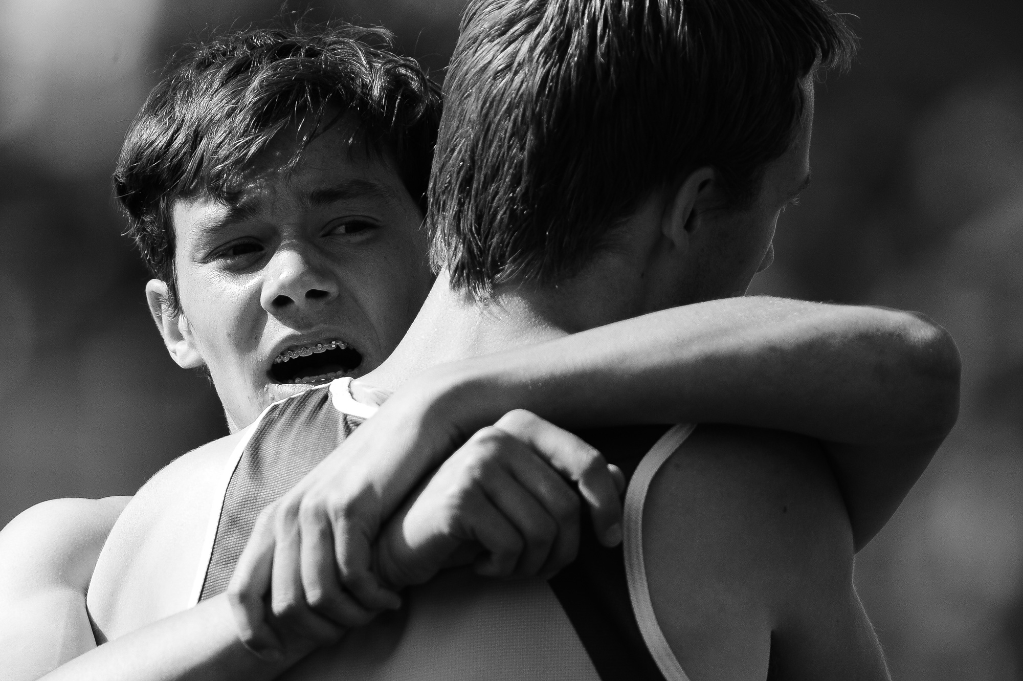 Toby Dilworth of Glenelg High School grabs ahold of a competitor after completing the boys 1600 meter race on the second day of the Howard County Track Championships at Wilde Lake High School in Columbia, Maryland on May 6, 2014.