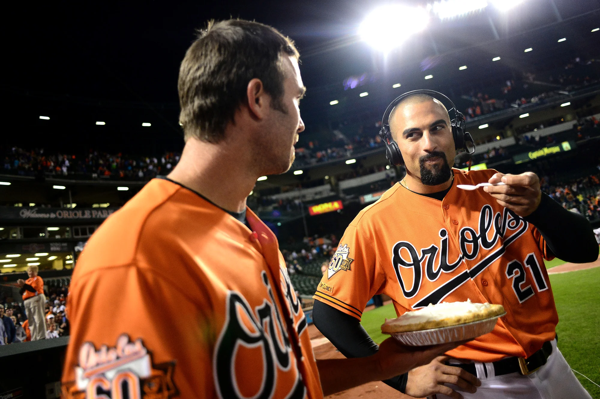 J.J. Hardy of the Baltimore Orioles, left, offers some pie to Nick Markakis of the Baltimore Orioles after a game against the Kansas City Royals on April 26, 2014 in Baltimore, Maryland. 