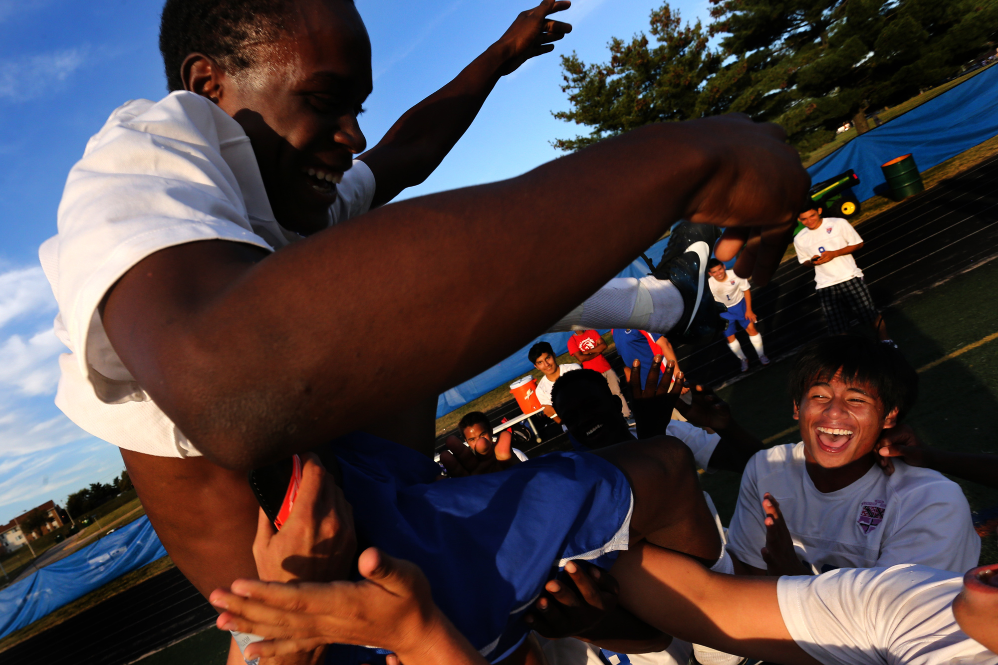 Members of the Landsdowne boys soccer team throw Jermaine Desoto into the air during celebration after Desoto scored the game winning goal in double over time against Overlea on Sept. 23, 2014 in Landsdowne, Maryland.
