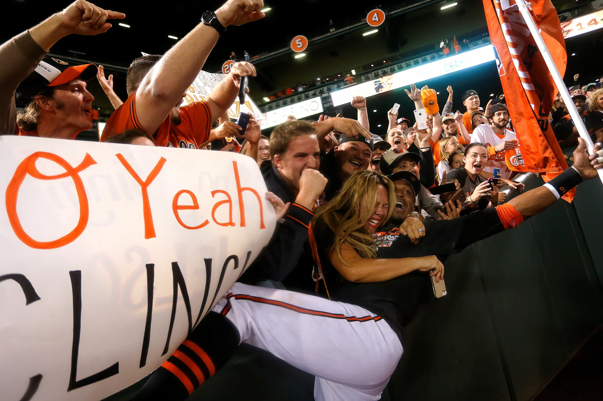 Center fielder Adam Jones of the Baltimore Orioles celebrates with fans after the Orioles defeated the Toronto Blue Jays to clinch the American League East Division at Oriole Park at Camden Yards in Baltimore, Maryland on Sept. 16, 2014. 