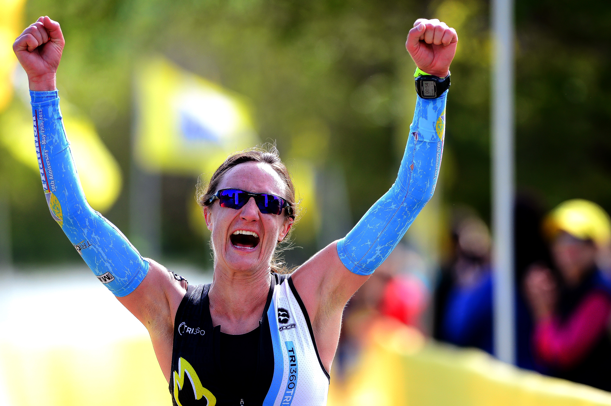  Kyra Wiens of Alexandria, Virginia celebrates after finishing third overall during the 31st annual Columbia Triathlon at Centennial Park in Ellicott City, Maryland on May 18, 2014. 