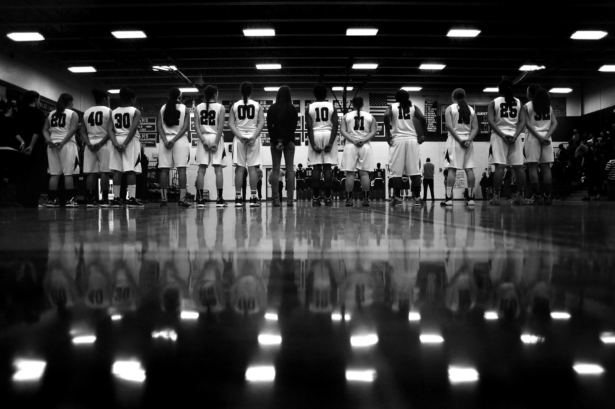 Atholton High School girl's basketball lines up for the national anthem before the start of the regional finals game in Columbia, Maryland on March 8, 2014.