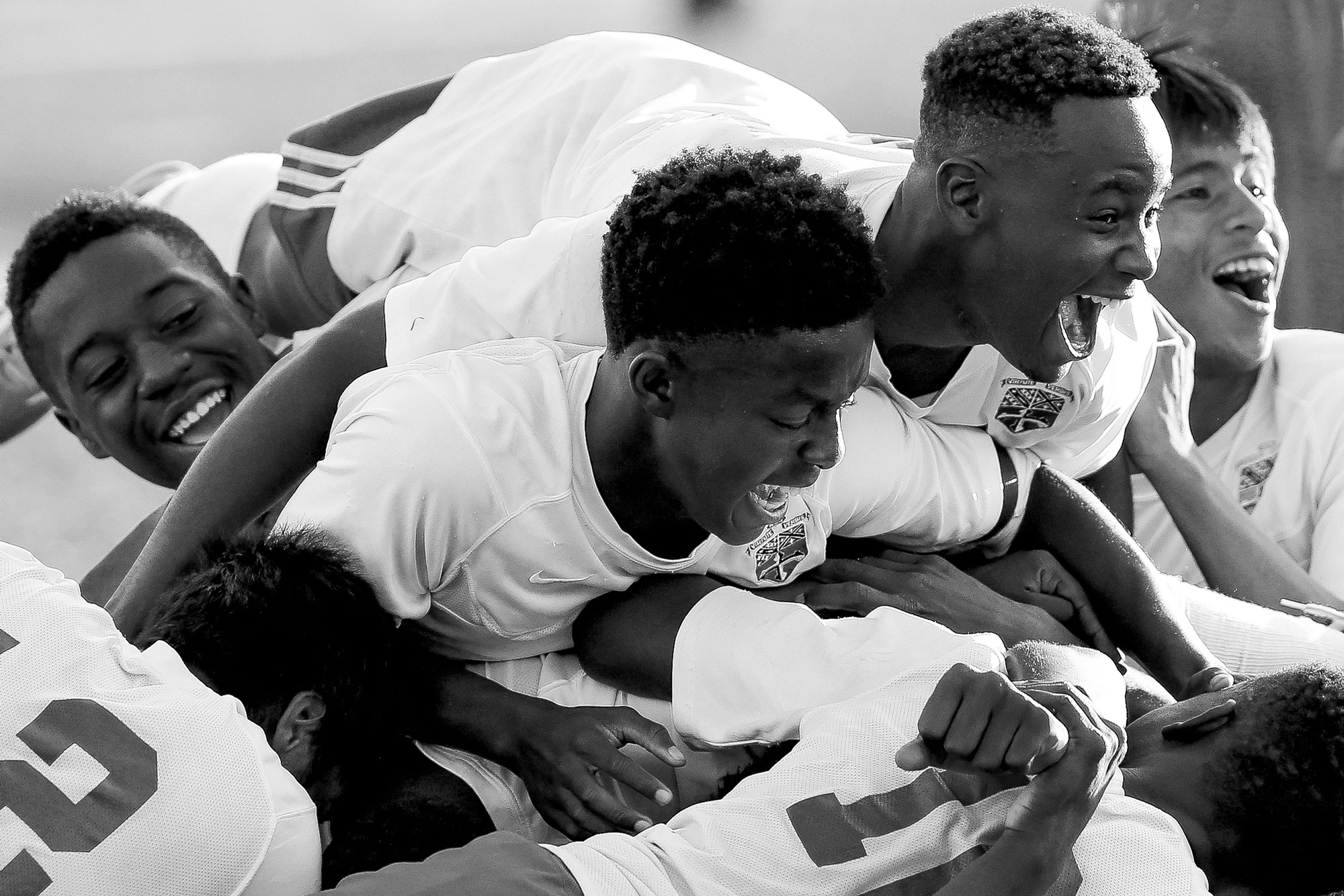 Members of the Landsdowne boys soccer dog piles on top of Jermaine Desoto after he scored the game winning goal in double overtime during a game against Overlea on Sept. 23, 2014 in Landsdowne, Maryland. 