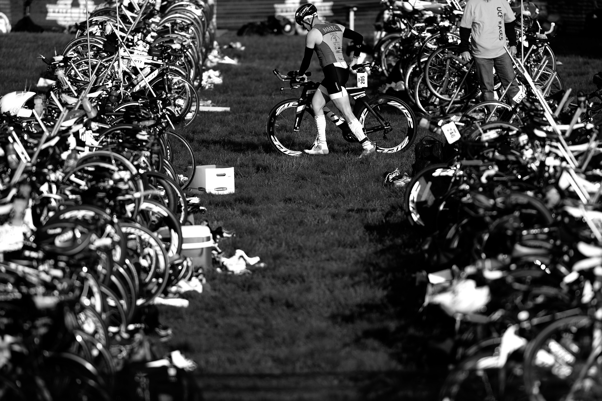 A participant of the 31st annual Columbia Triathlon at Centennial Park grabs his bike during the race in Ellicott City, Maryland on May 18, 2014.
