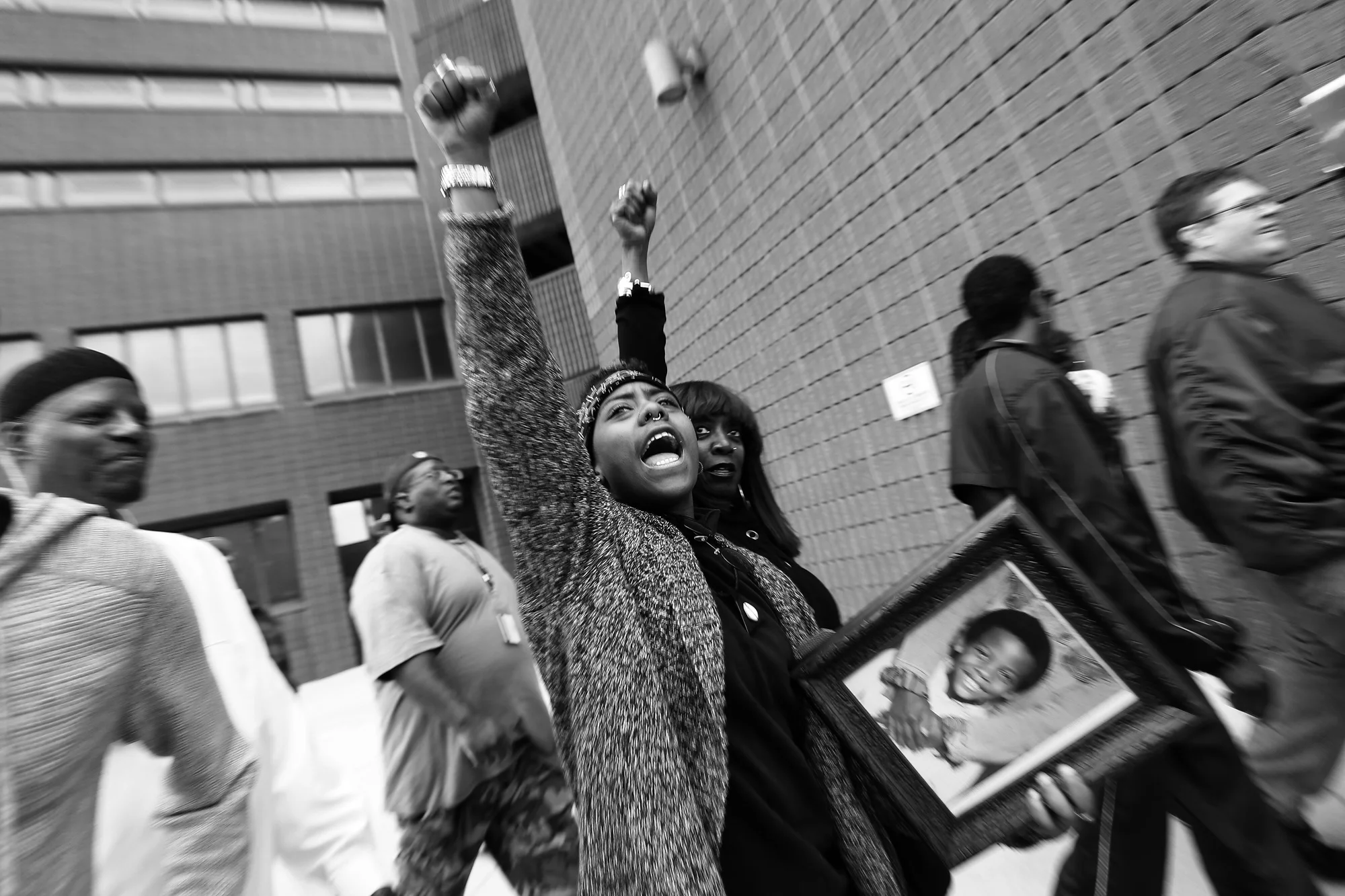 Protestors march around the Baltimore City Detention Center on 401 E. Eager Street after the announcement that all six officers will be charged following the death of Freddie Gray while he was in police custody, May 1, 2015 in Baltimore, Maryland.