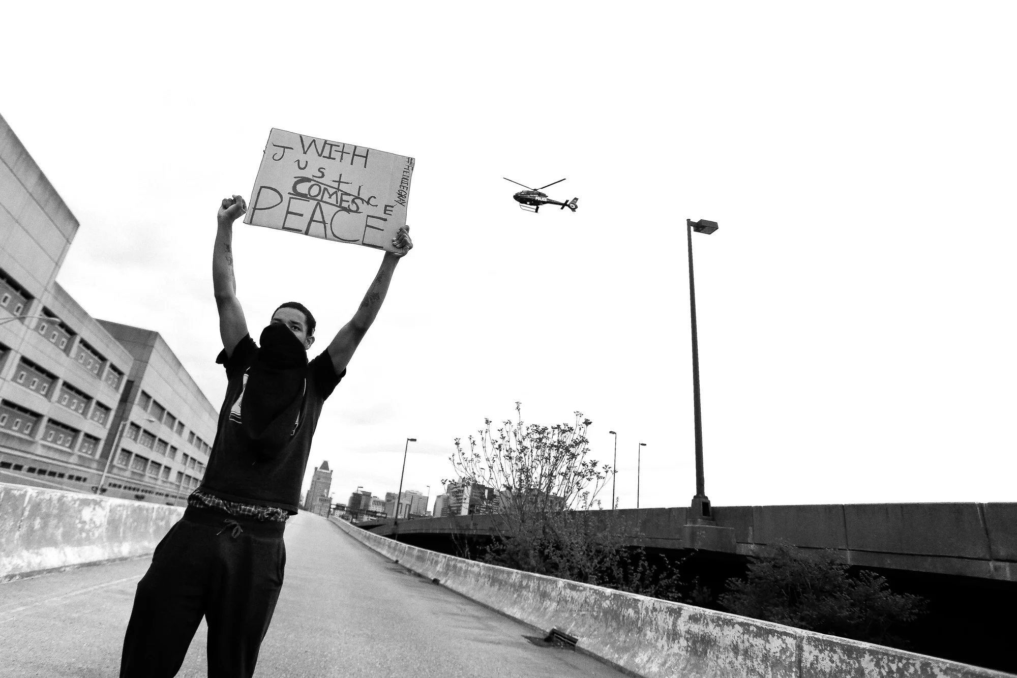 A protestor stands on an exit ramp for I-83 North near the Baltimore City Detention Center on 401 E. Eager Street after the announcement that all six officers will be charged following the death of Freddie Gray while he was in police custody, May 1, 2015 in Baltimore, Maryland.