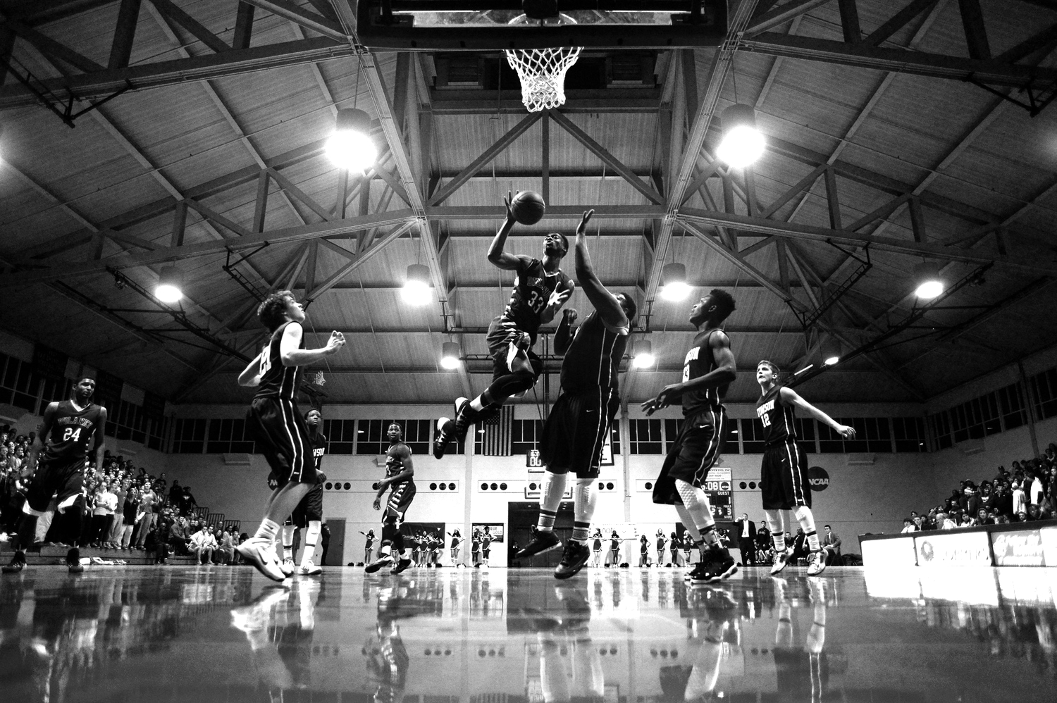 Forward Jon Sims, left, of Dulaney High School shoots overtop of center Joe Jackson of Towson High School during a boy's basketball game in Towson, Maryland on December 18, 2013.