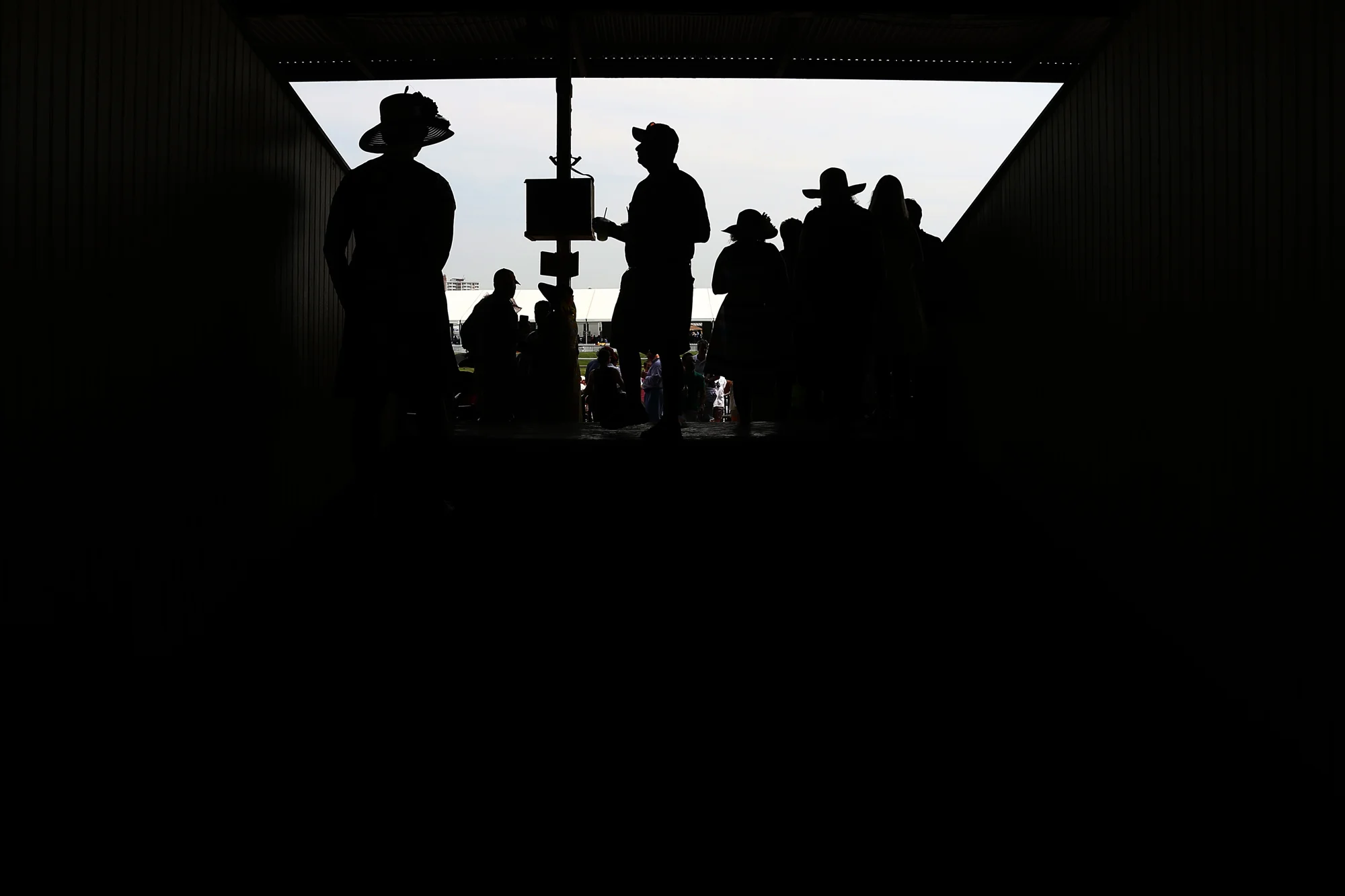 Fans walk through the grandstand before the start of the 140th Preakness Stakes at Pimlico Race Course on May 16, 2015 in Baltimore, Maryland.