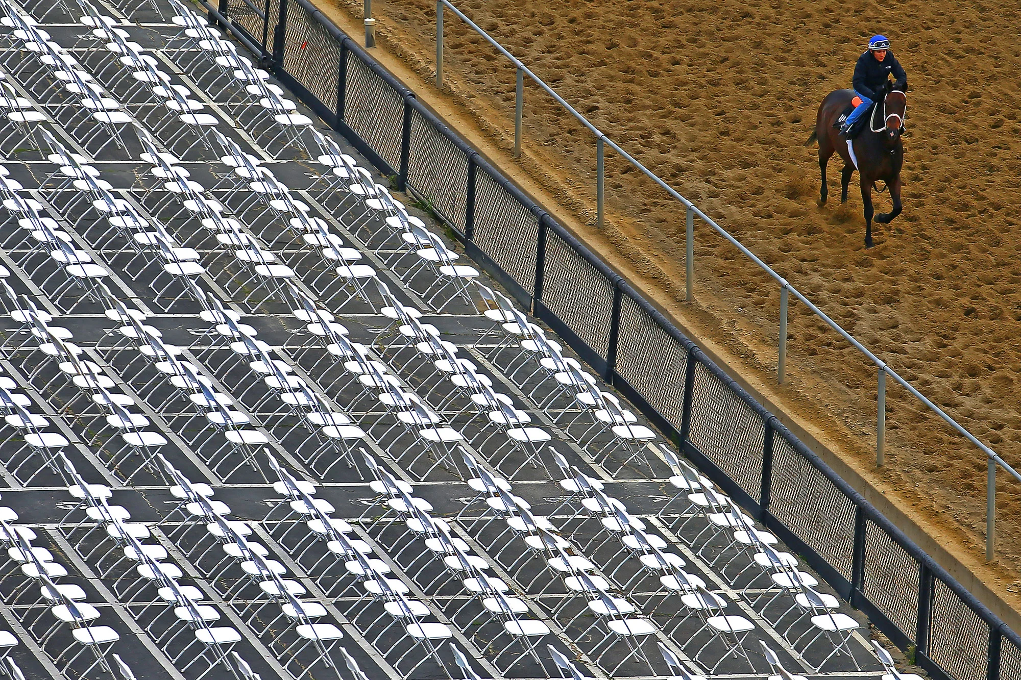 A horse and jockey walk the track one day prior to the 140th Preakness Stakes at Pimlico Race Course on May 15, 2015 in Baltimore, Maryland.