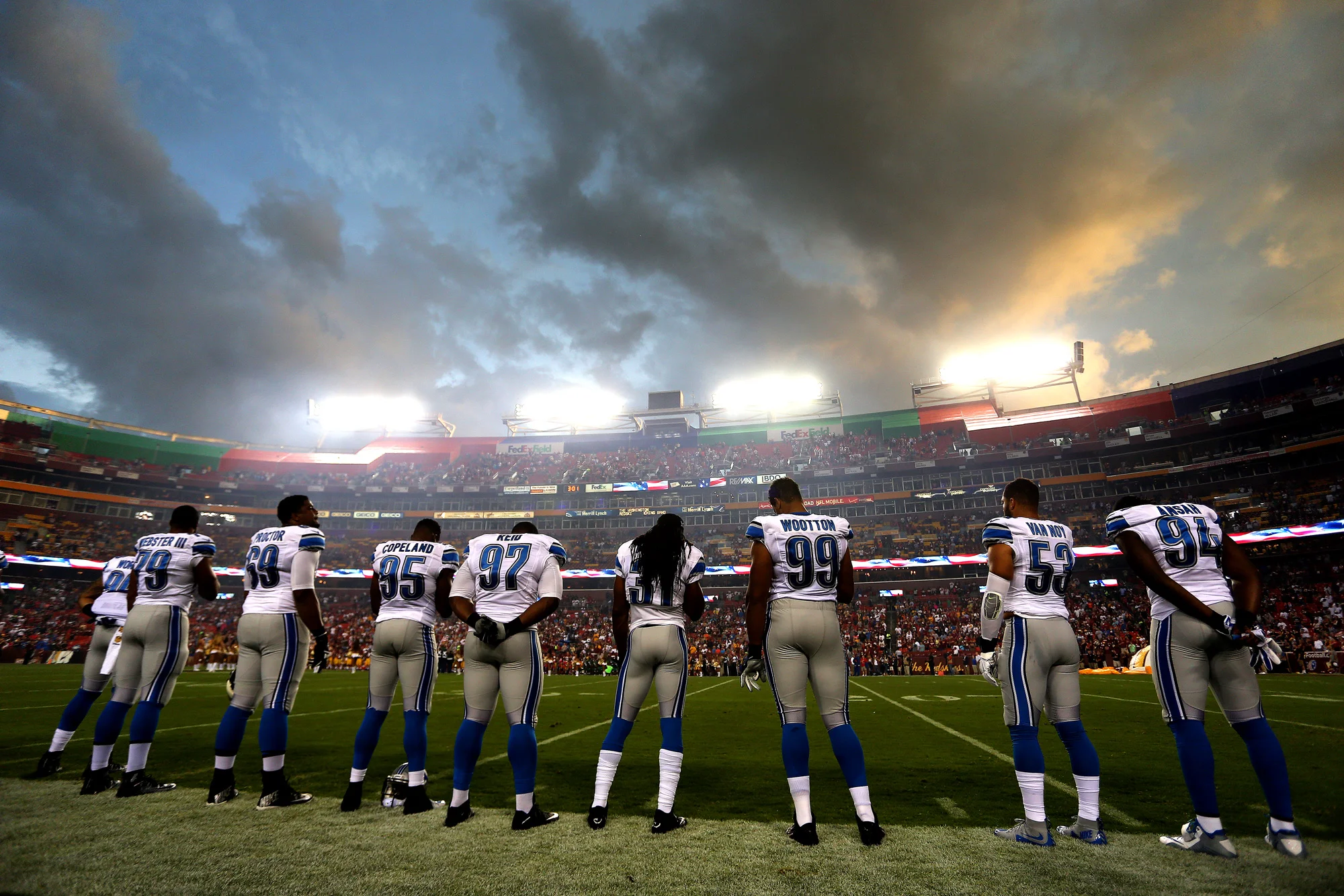 Members of the Detroit Lions stand for the playing of the national anthem before a preseason game against the Washington Redskins at FedEx Field on August 20, 2015 in Landover, Maryland.