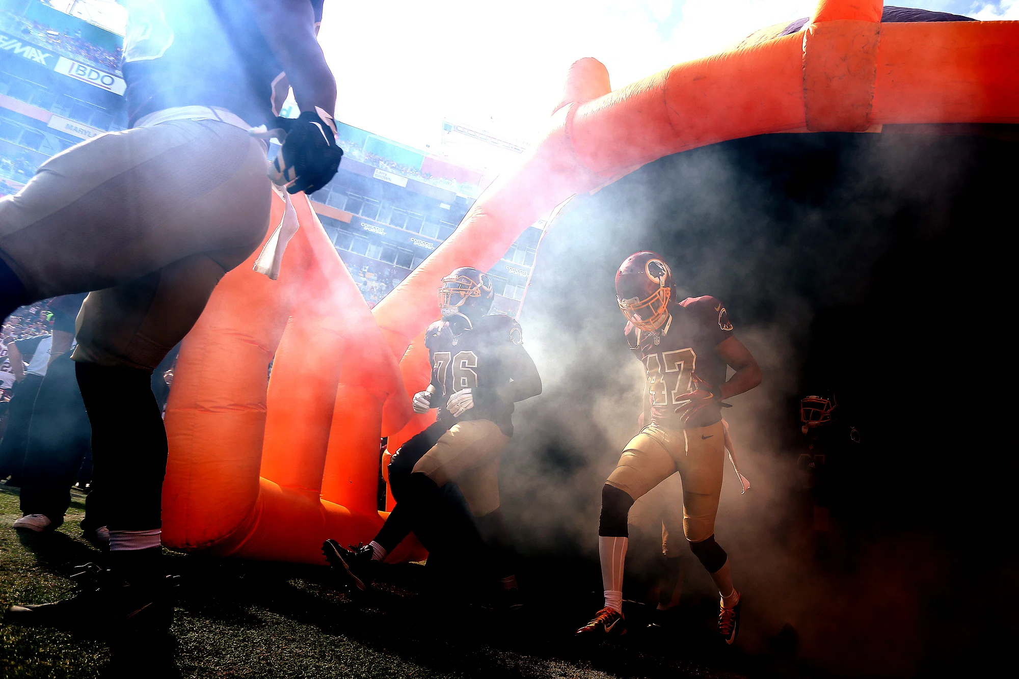 Wide receiver Quinton Dunbar #47 of the Washington Redskins and tackle Morgan Moses #76 of the Washington Redskins run onto the field prior to a game against the Tampa Bay Buccaneers at FedExField on October 25, 2015 in Landover, Maryland.