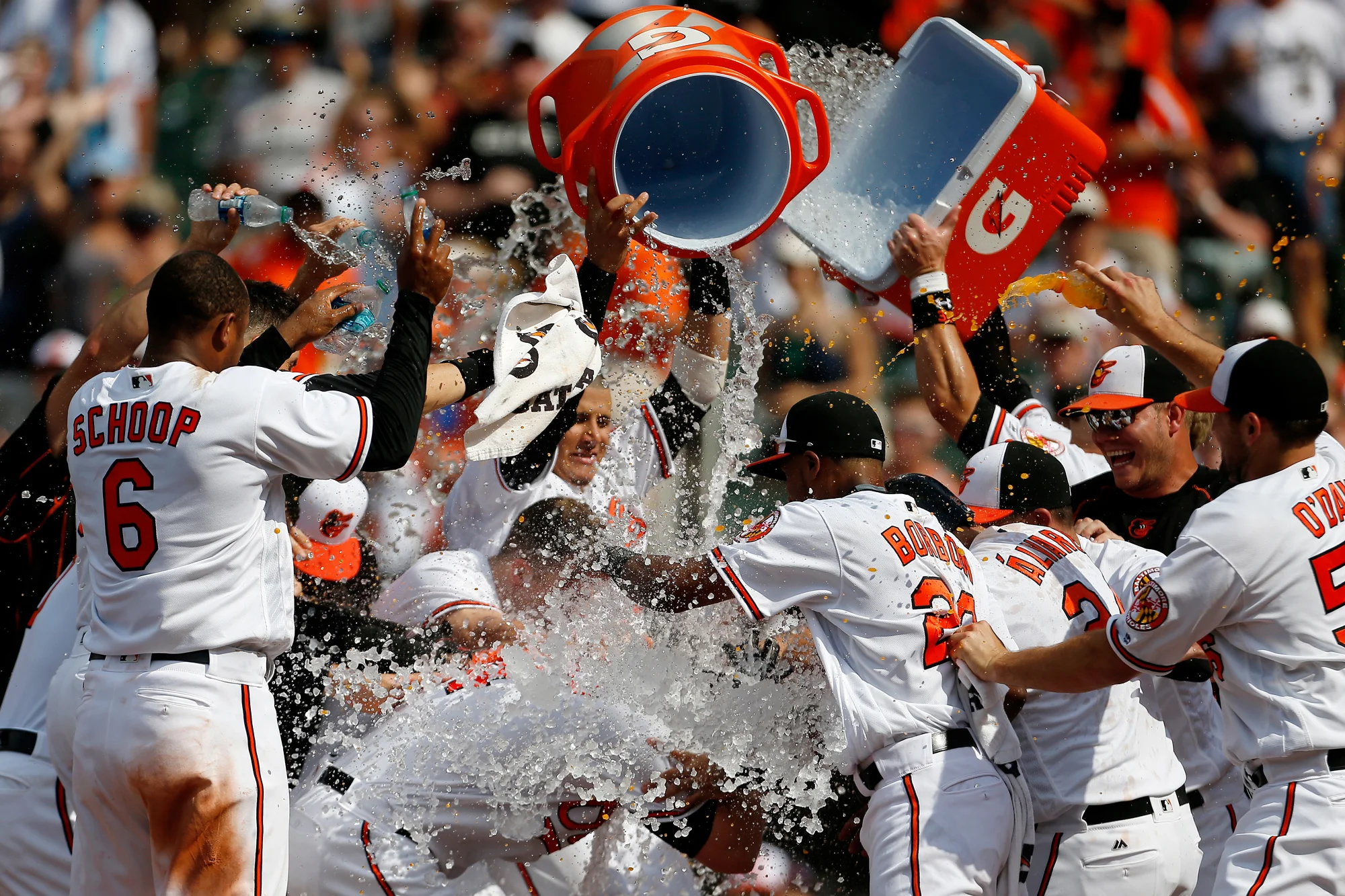 Nolan Reimold #14 of the Baltimore Orioles is swarmed by his teammates at home plate after hitting a two run walk-off home run in the ninth inning to defeat the Cleveland Indians 5-3 at Oriole Park at Camden Yards on July 24, 2016 in Baltimore, Maryland.