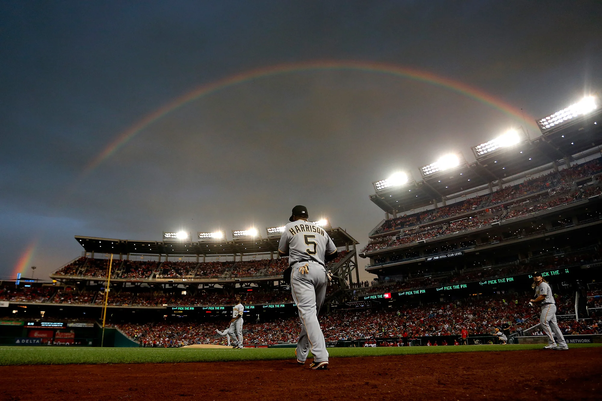 Josh Harrison #5 of the Pittsburgh Pirates walks onto the field under a rainbow in the first inning against the Washington Nationals at Nationals Park on July 16, 2016 in Washington, DC.