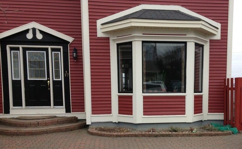 Before - black windows and door with improper stonework