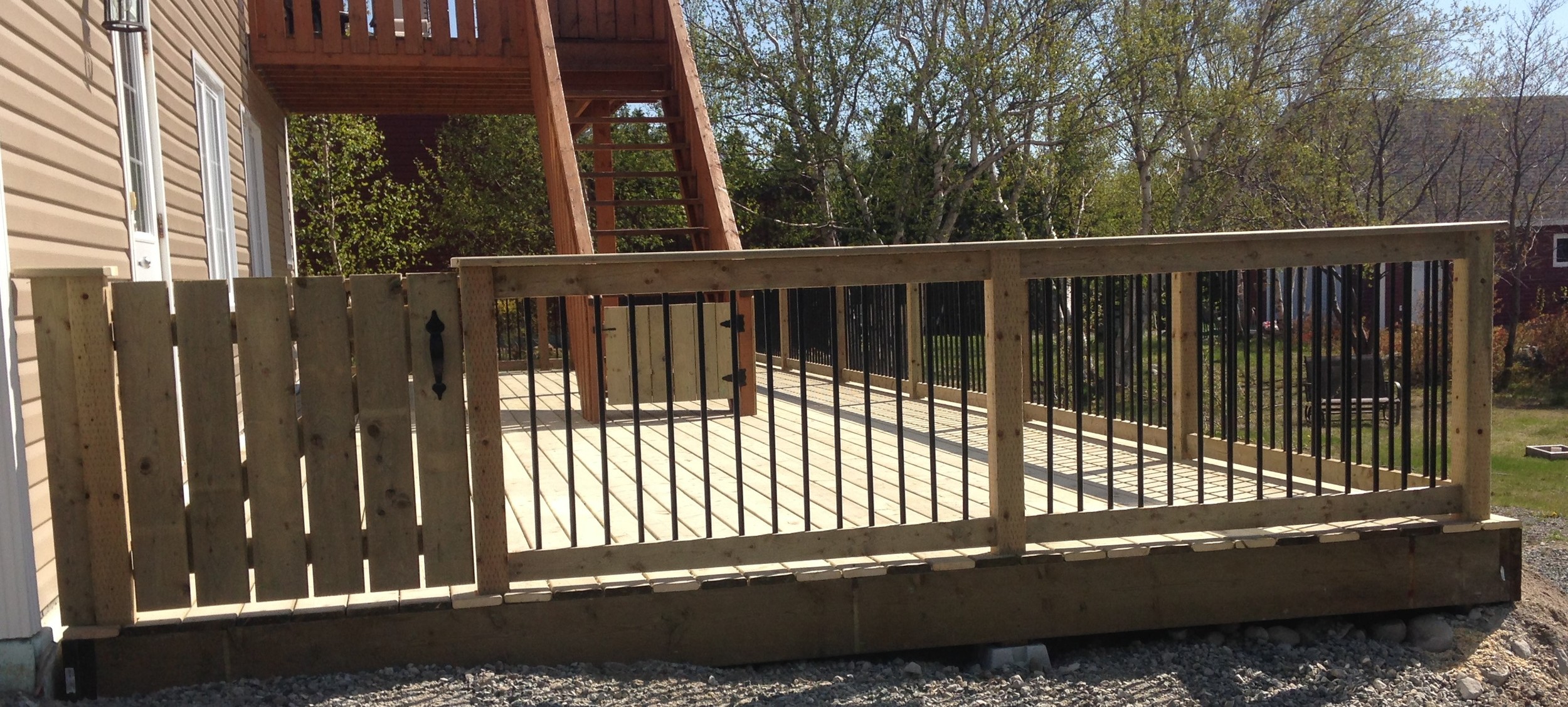 14' x 40' deck with wooden rails and rod iron spindles. 