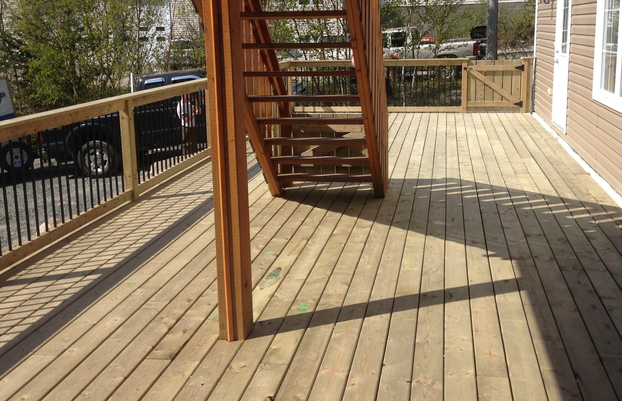 14' x 40' deck with wooden rails and rod iron spindles. 