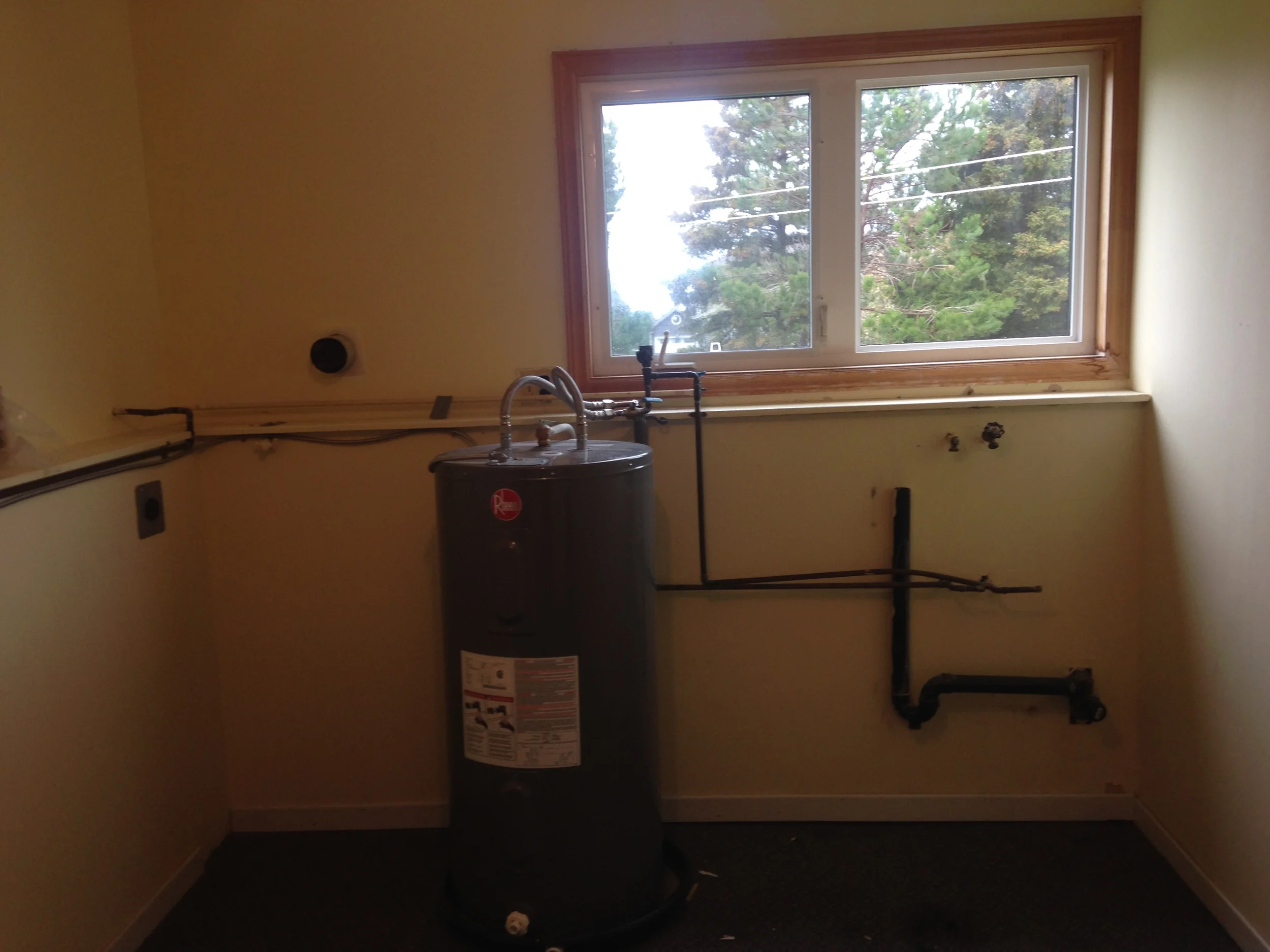 Before - Dated with exposed plumbing and water heater