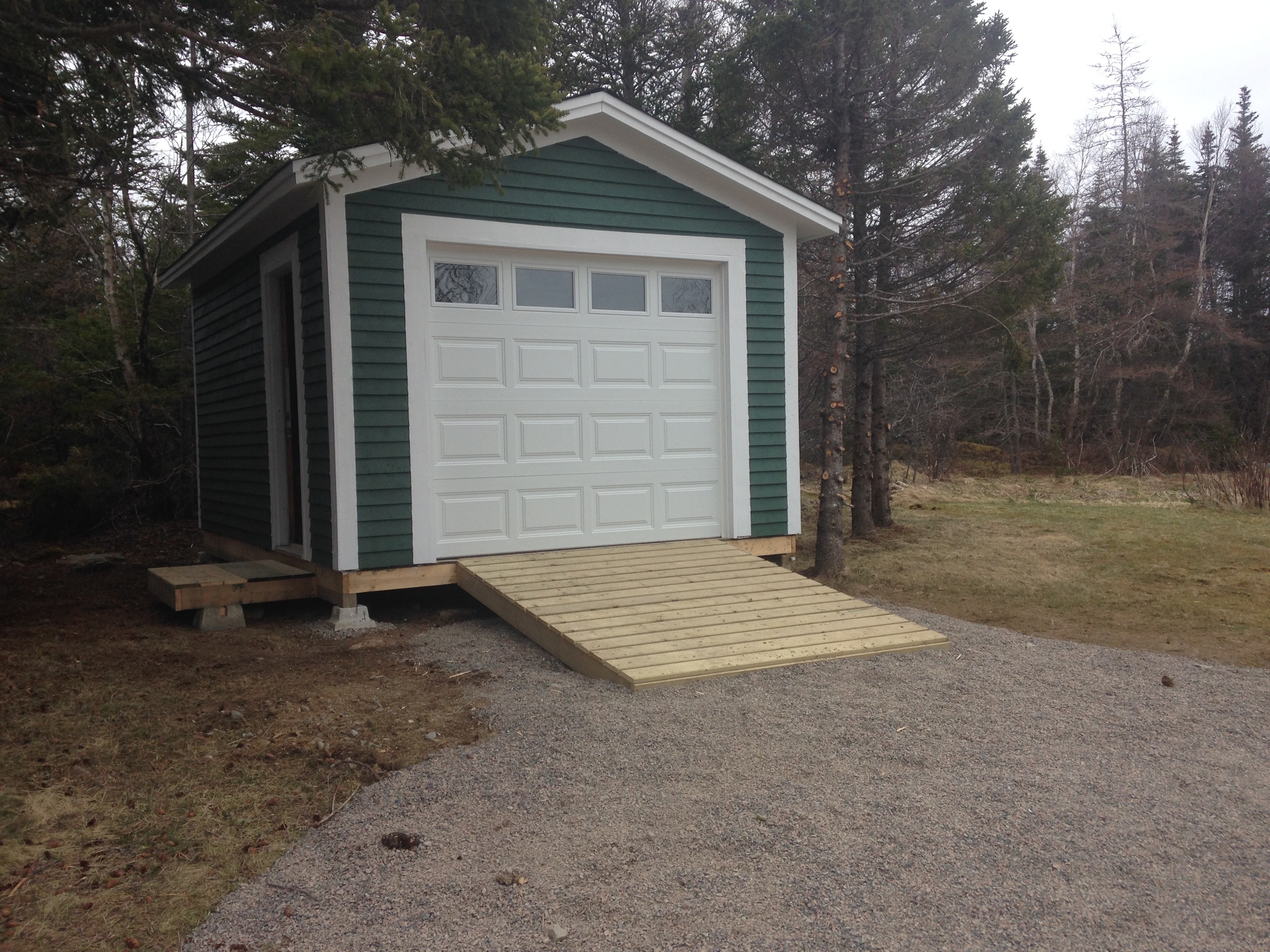 New shed with overhead door and ramp for toys and tools