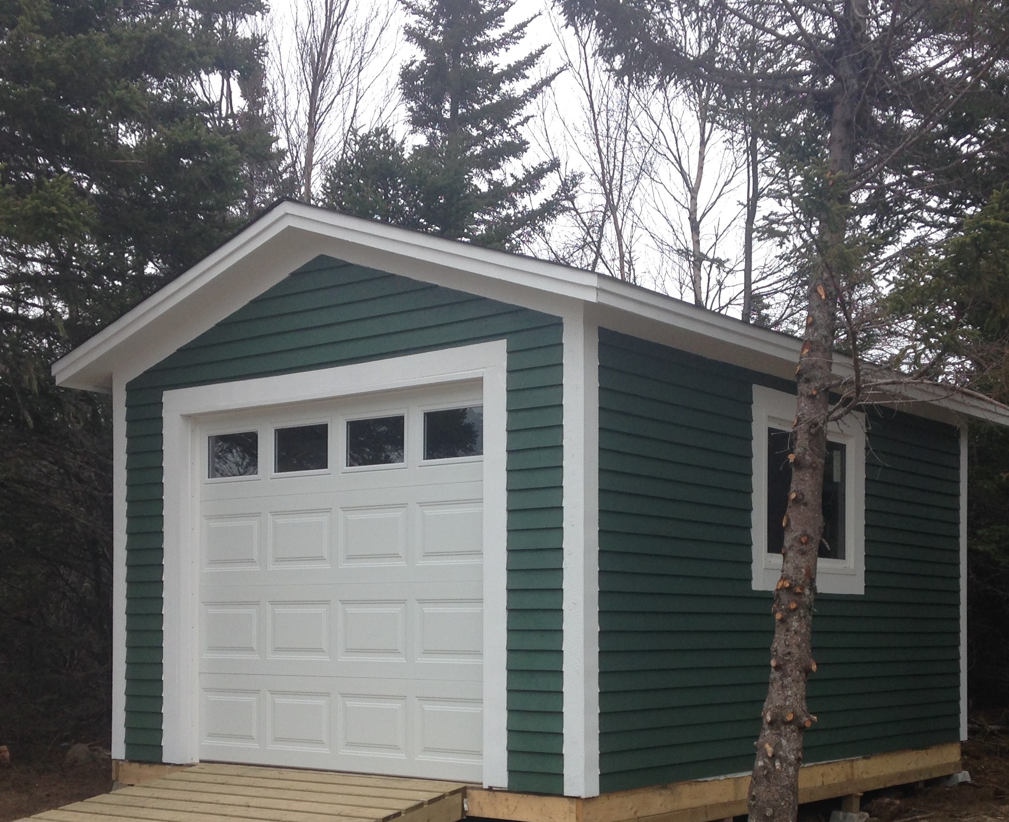 New shed with overhead door and ramp for toys and tools