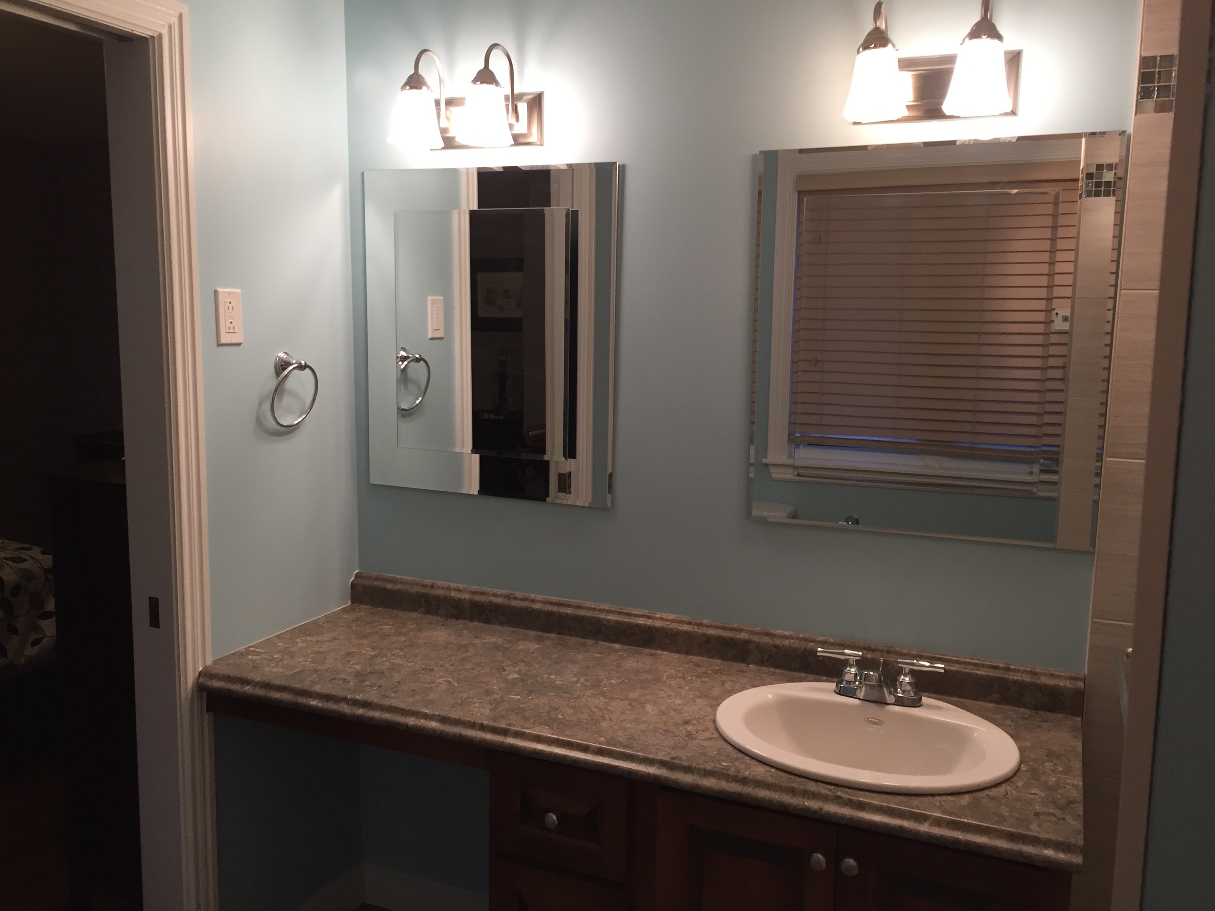 Updated lighting, mirrors and functional vanity with makeup area. 