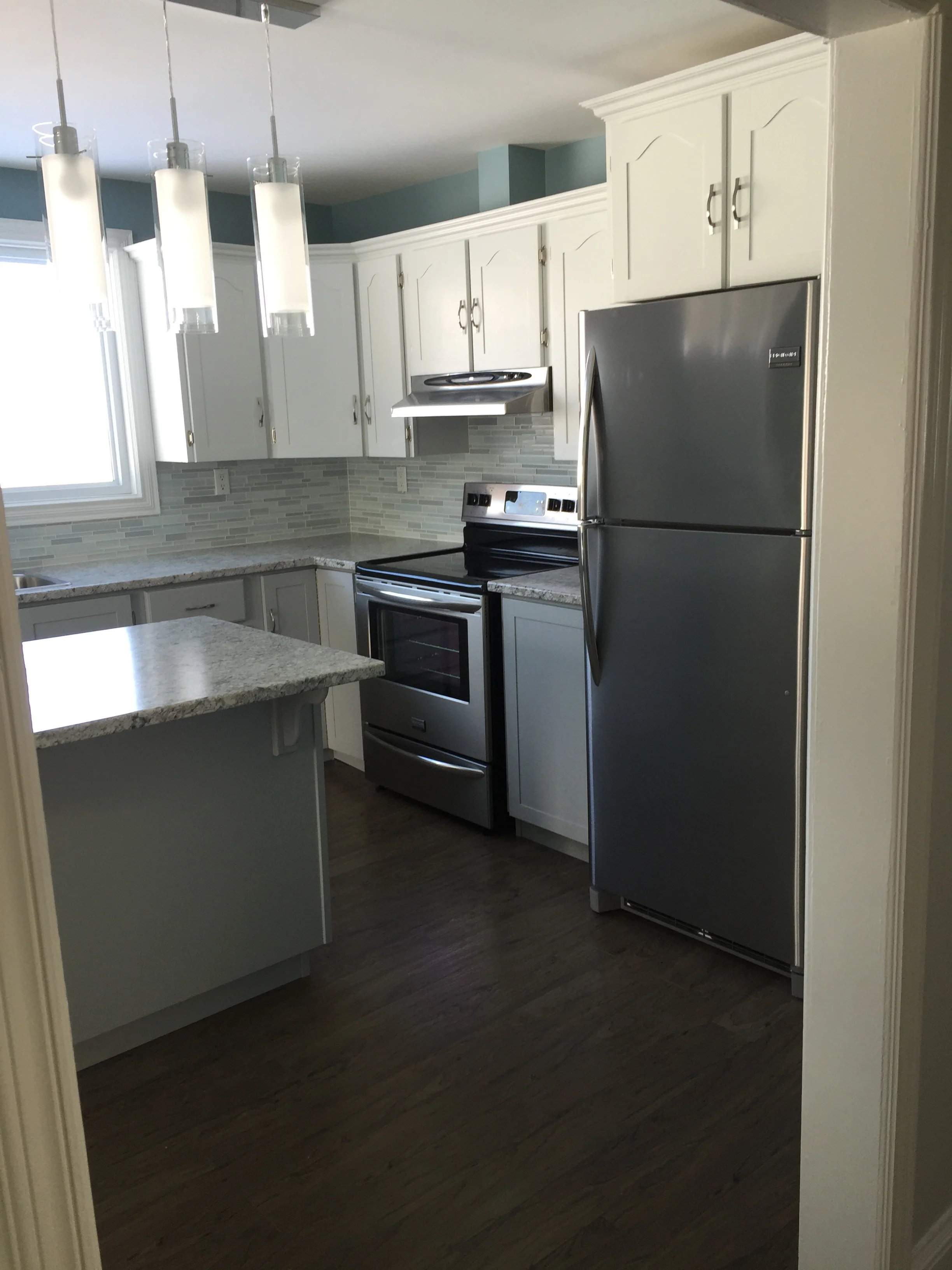New stainless steel appliances and a glass backsplash provide beautiful finishes. 