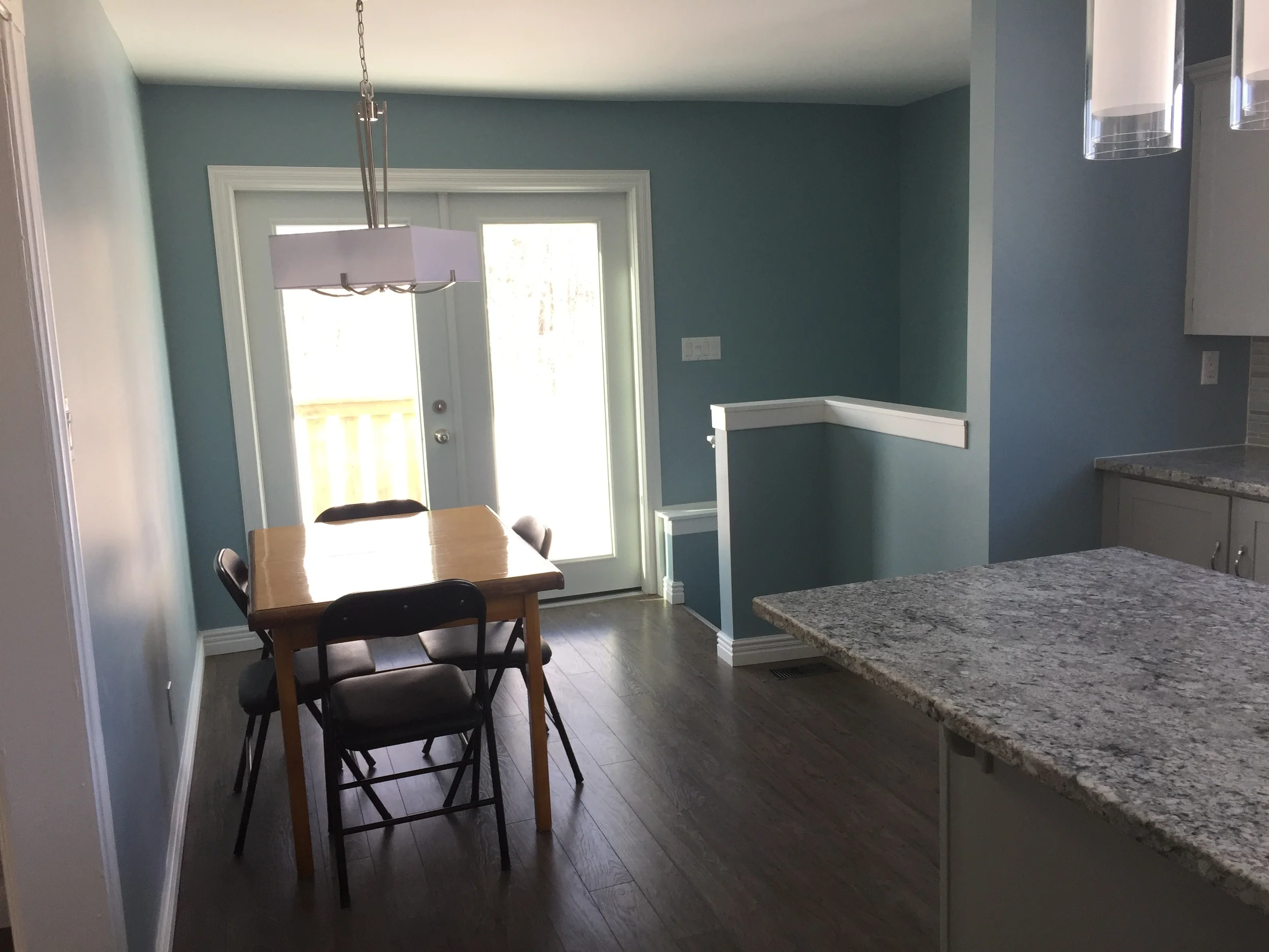 New outswing double garden door makes the space safer and brighter. The pantry and wall have been removed making for a more functional space. 