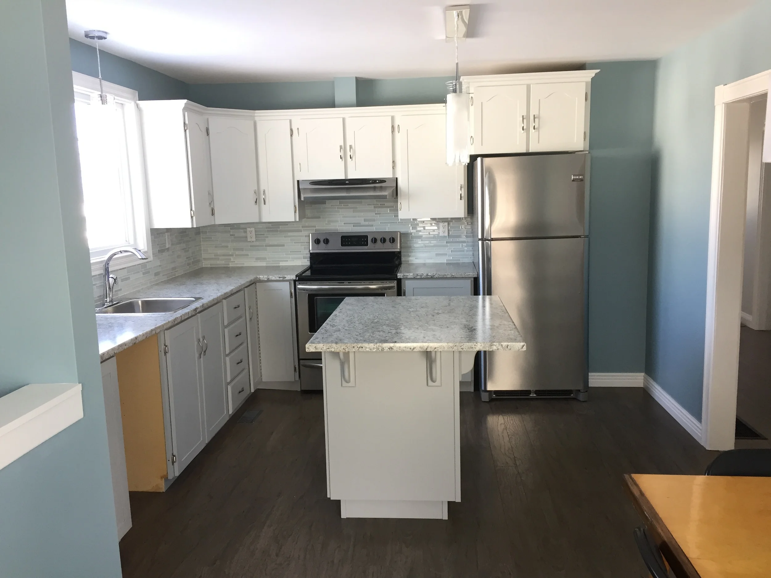 Grey lower cabinets with white uppers provide a beautifully modern look. Dishwasher to be installed once delivered. 