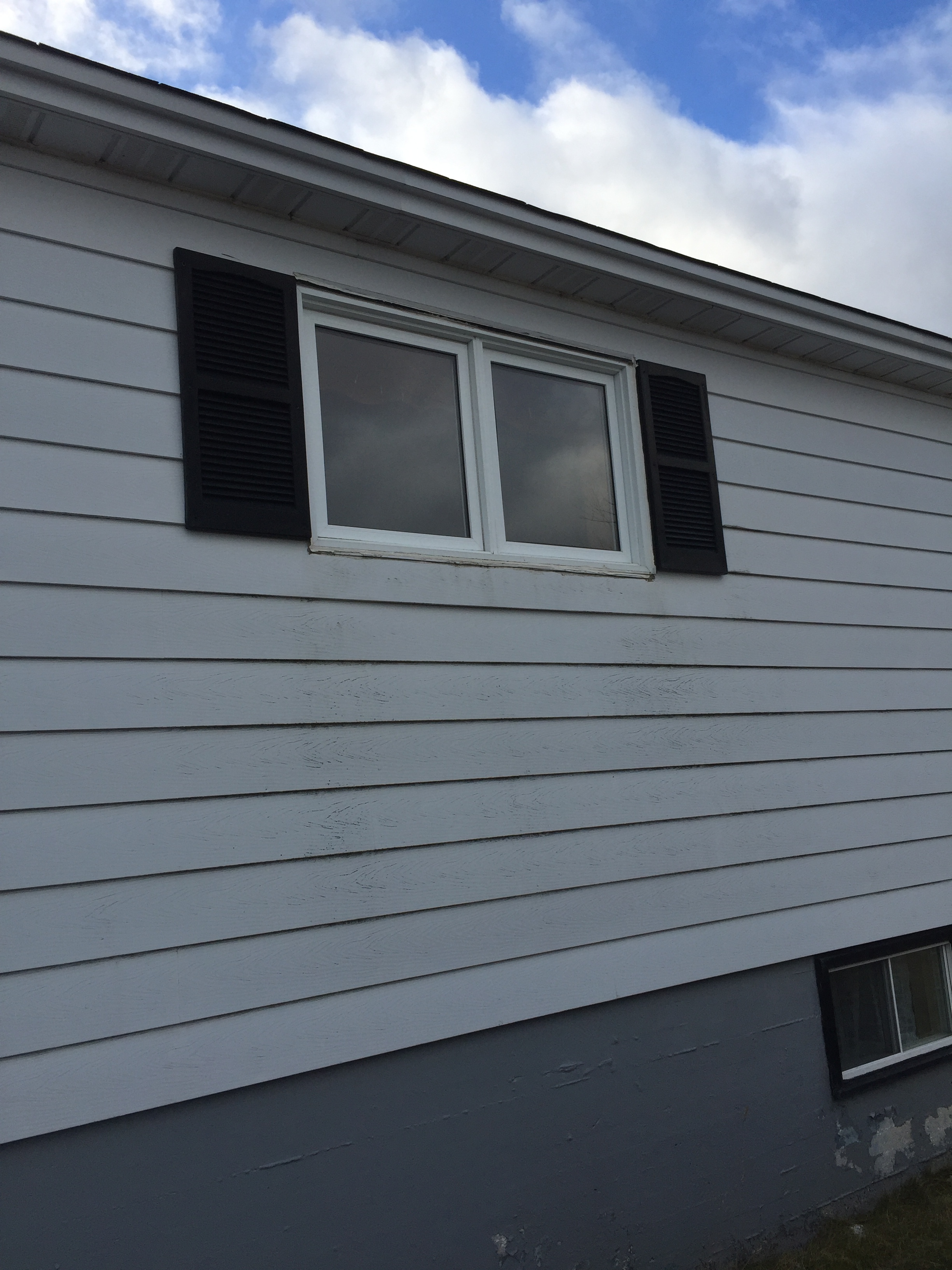 Before - Small kitchen window with aluminum siding and shutters