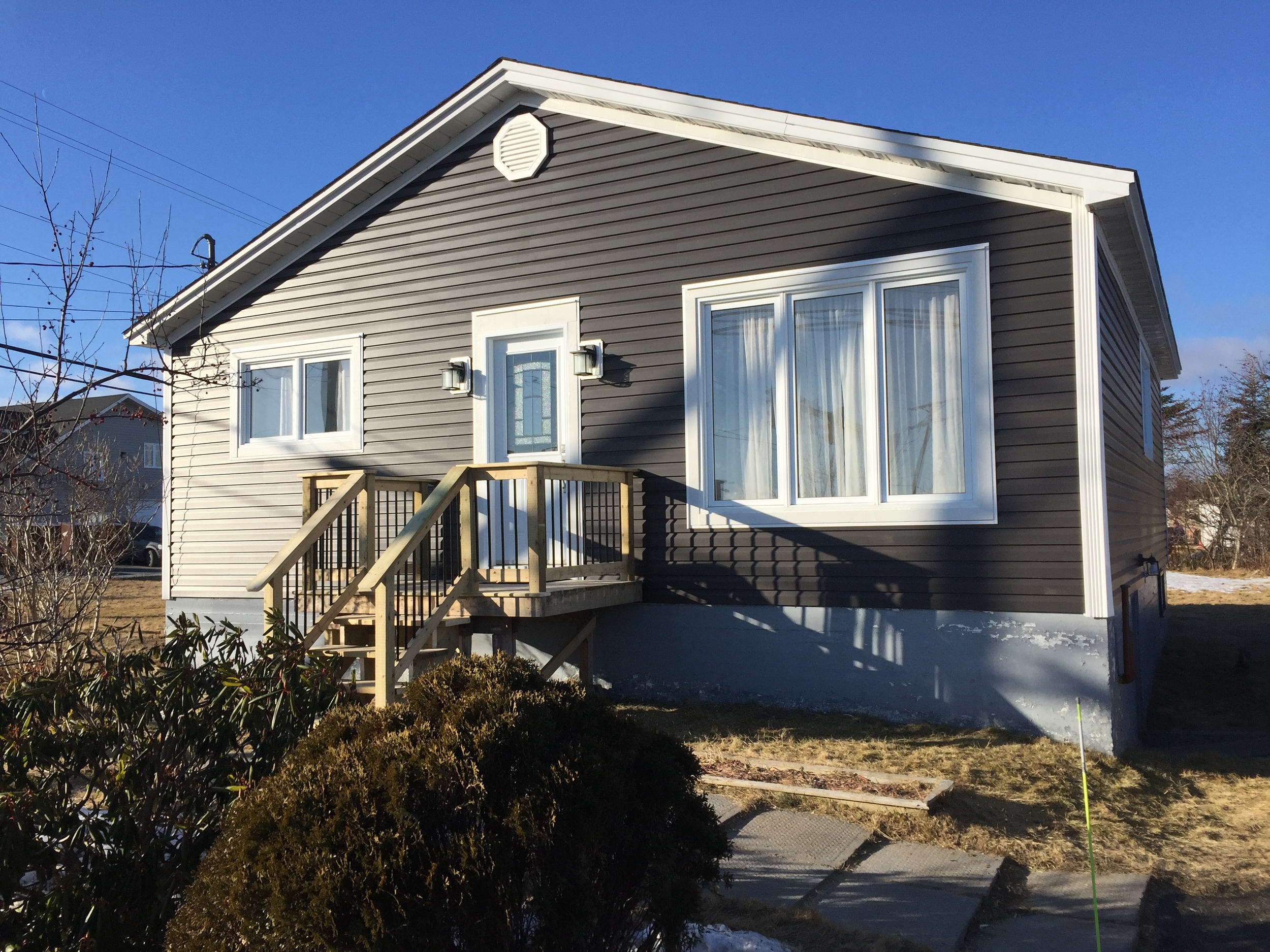 New siding with improved ventilation in gable, new front door and pressure treated step