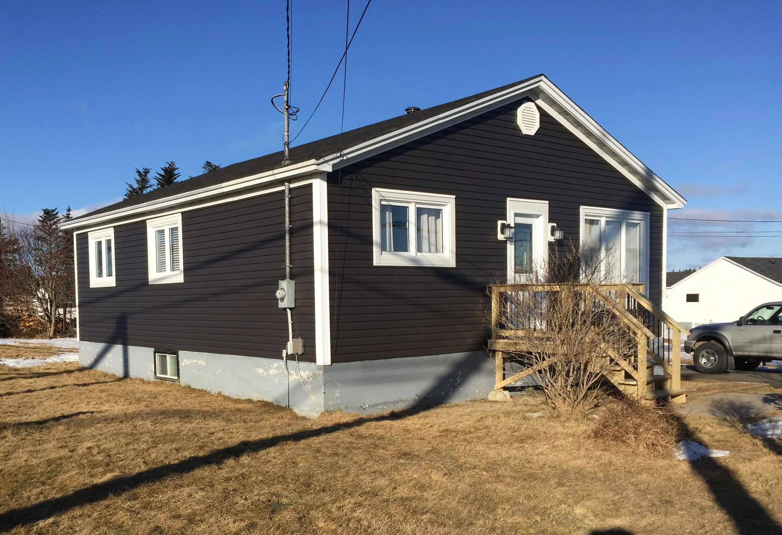 New vinyl siding with CapeCod trim around windows and door