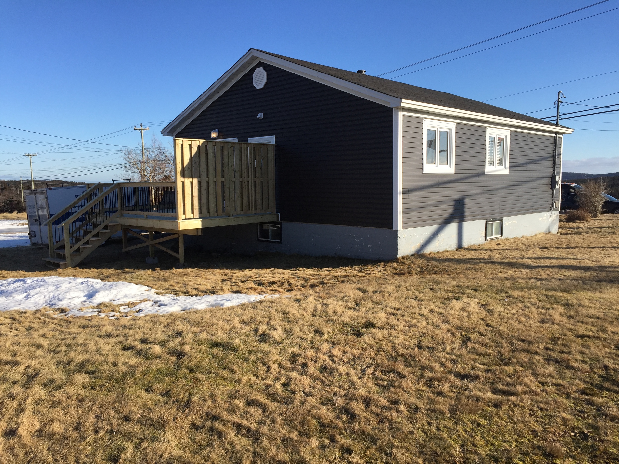 New siding, CapeCod trim and rear deck with privacy wall