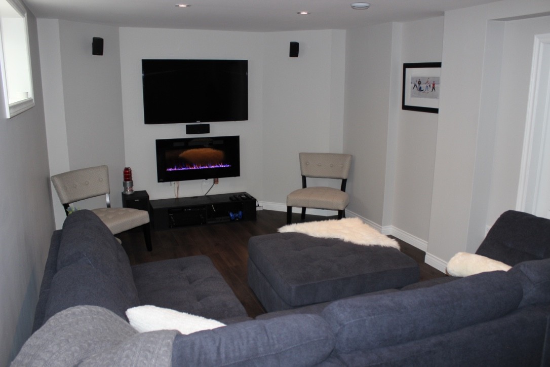 Furnished space with entertainment area, surround sound and electric fireplace.