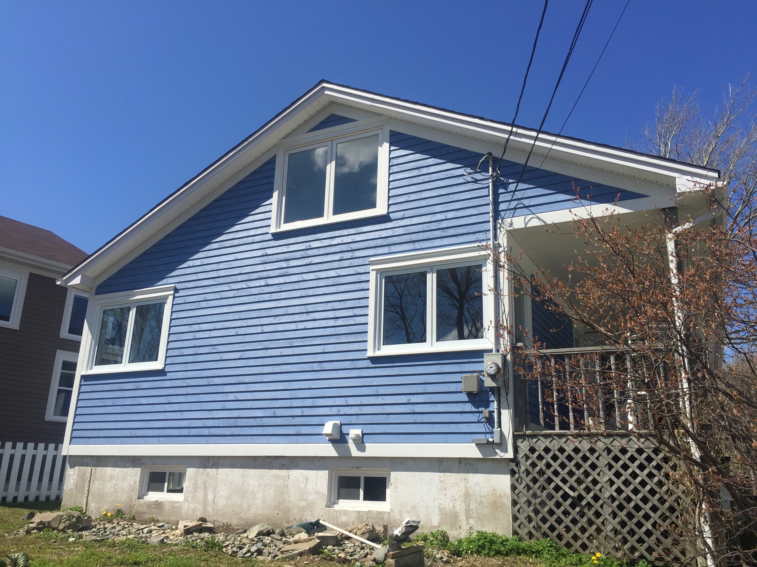 New Cape Cod siding, windows and finishes. 