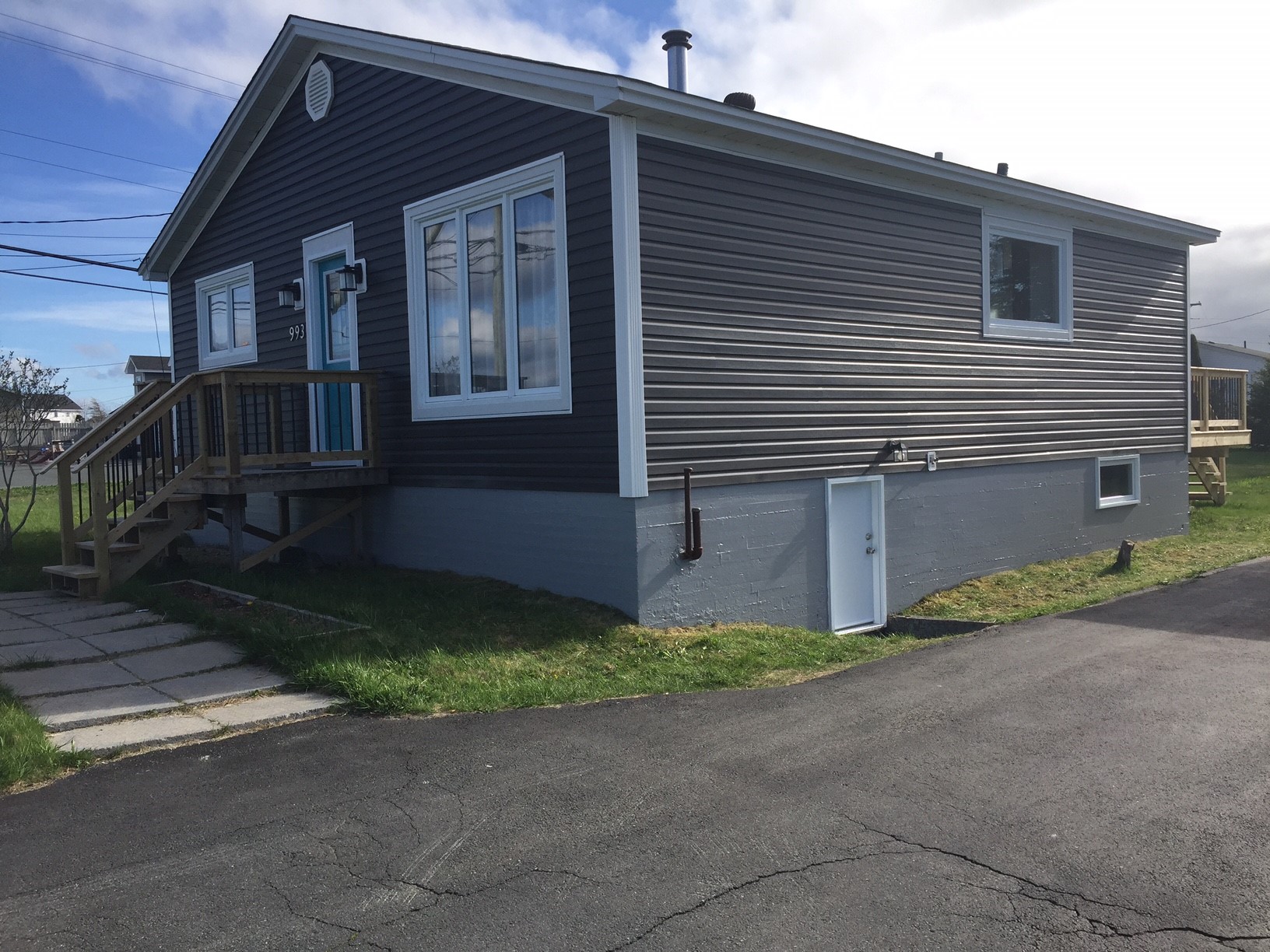 Painted front door, new custom basement door and painted foundation. 