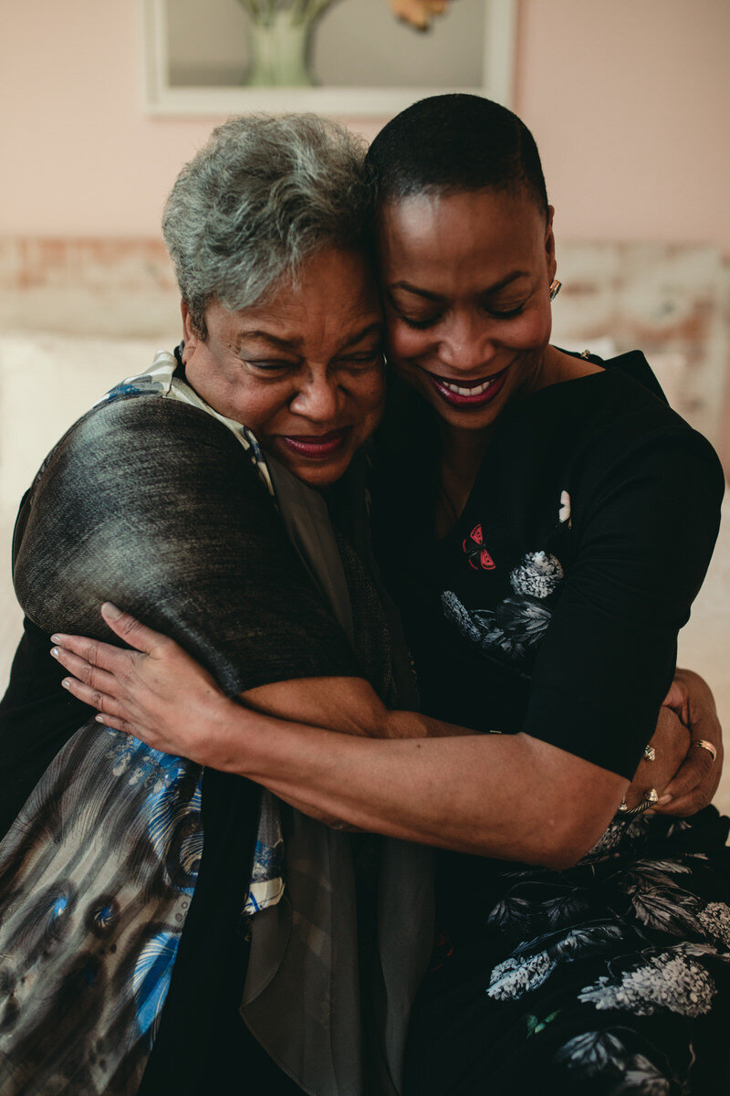 Black mother and daughter hugging before ceremony at Quirk Hotel Richmond VA Carly Romeo photography