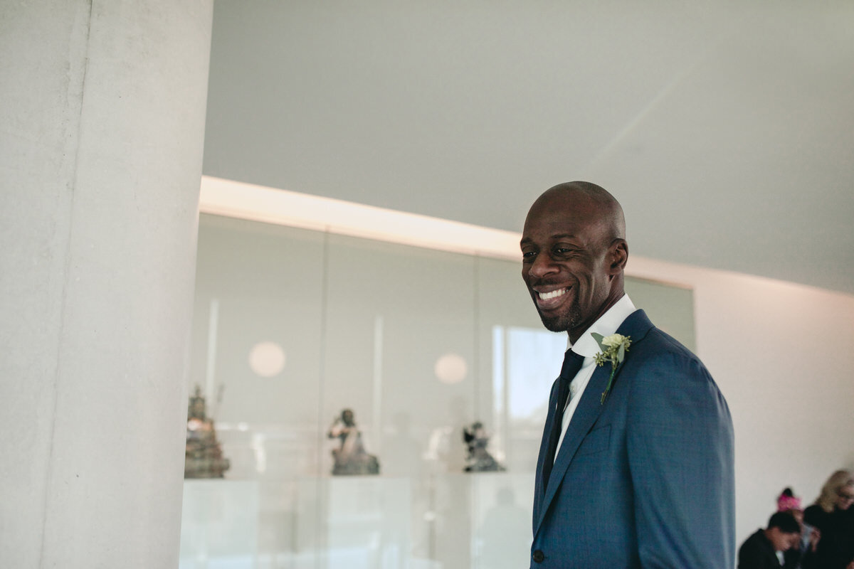 Black groom smiling at wedding ceremony at Virginia Museum of Fine Arts Richmond Carly Romeo &amp; Co