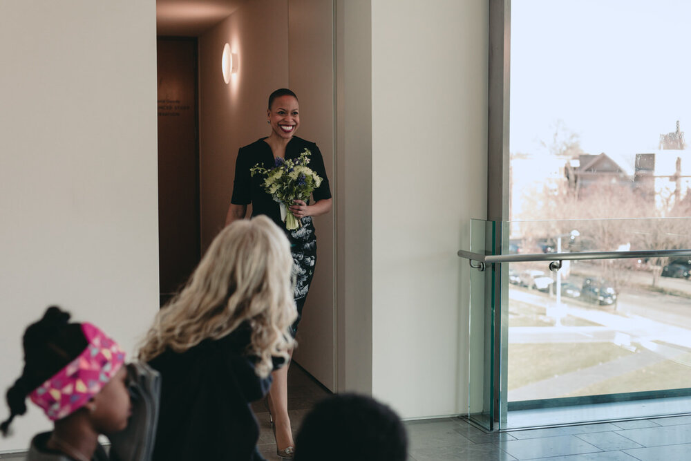 Black women walking down the isle at wedding ceremony VMFA Richmond Carly Romeo photography