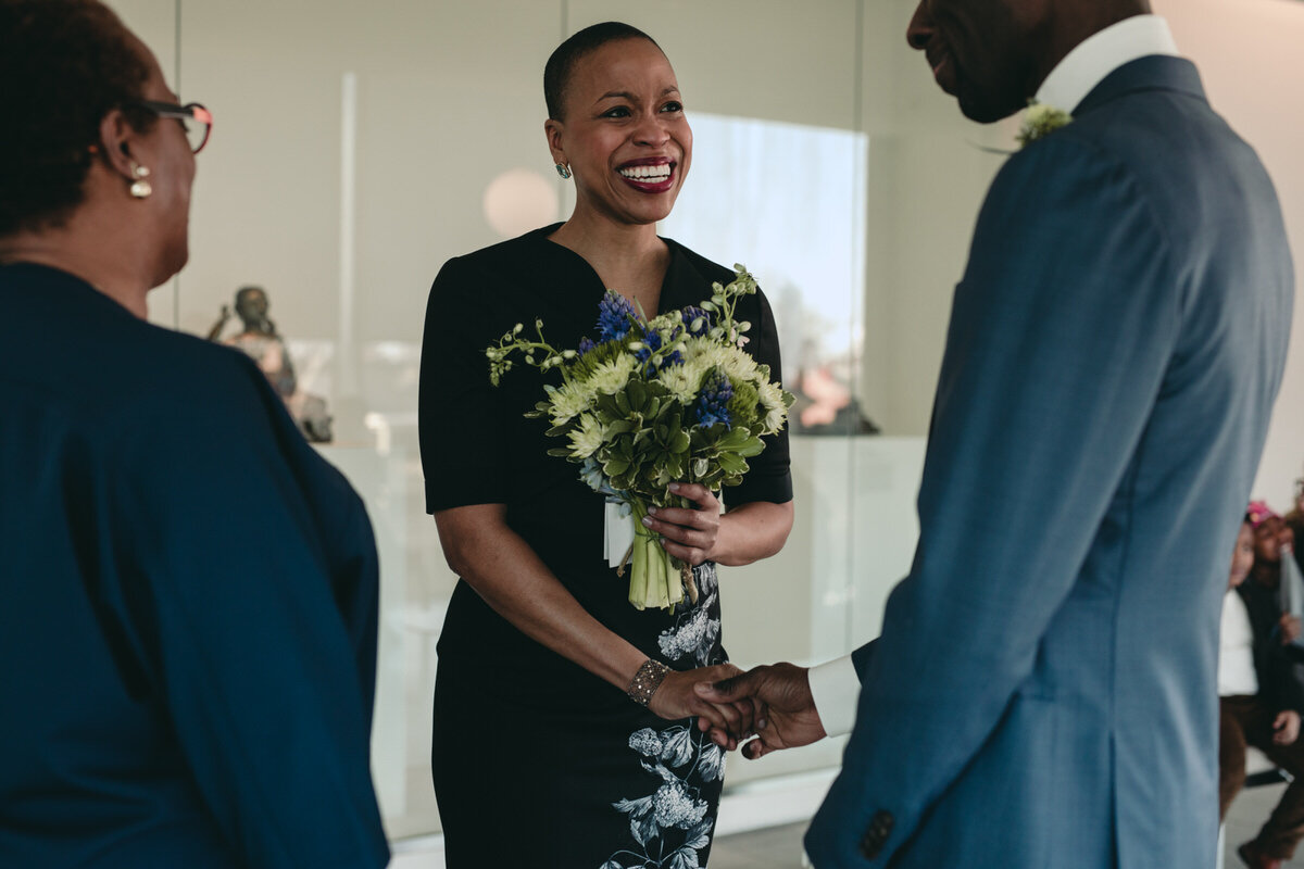 Bride smiling and getting married at the VMFA in Richmond Virginia Carly Romeo + CO.