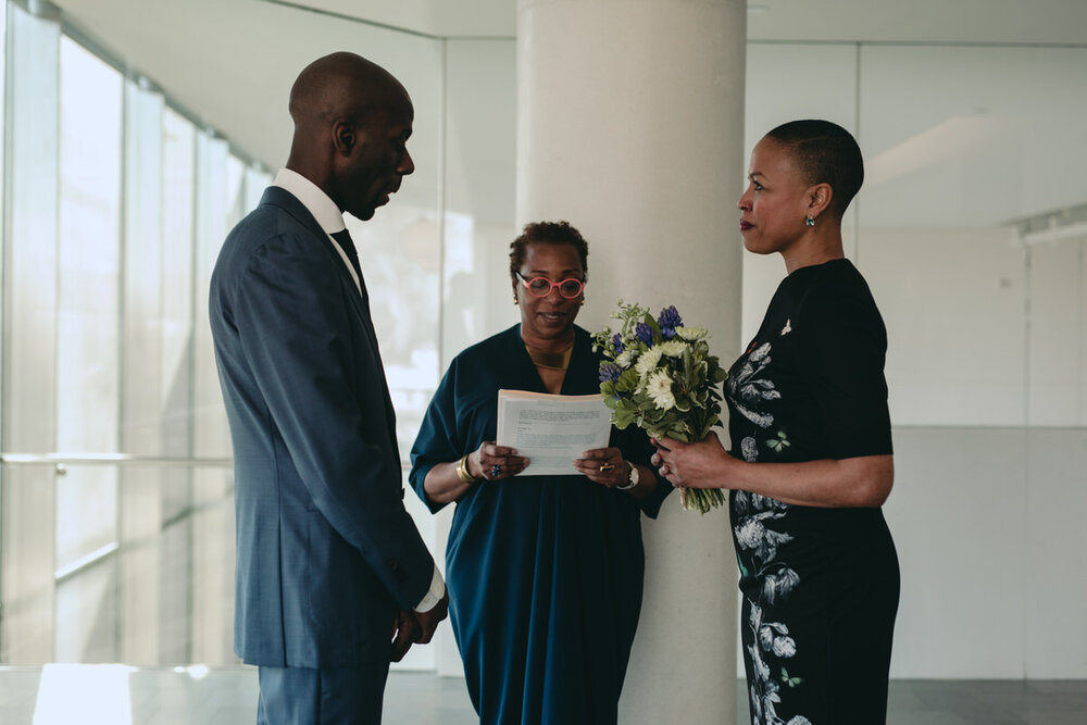 Black couple getting married by officiant at the MFA in Richmond Virginia feminist photography Carly Romeo