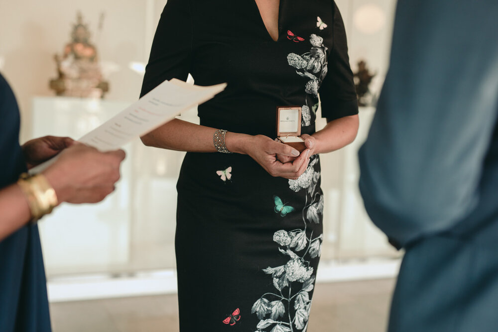 Woman holding wedding ring box at ceremony in the Virginia MFA in Richmond Carly Romeo + Co.