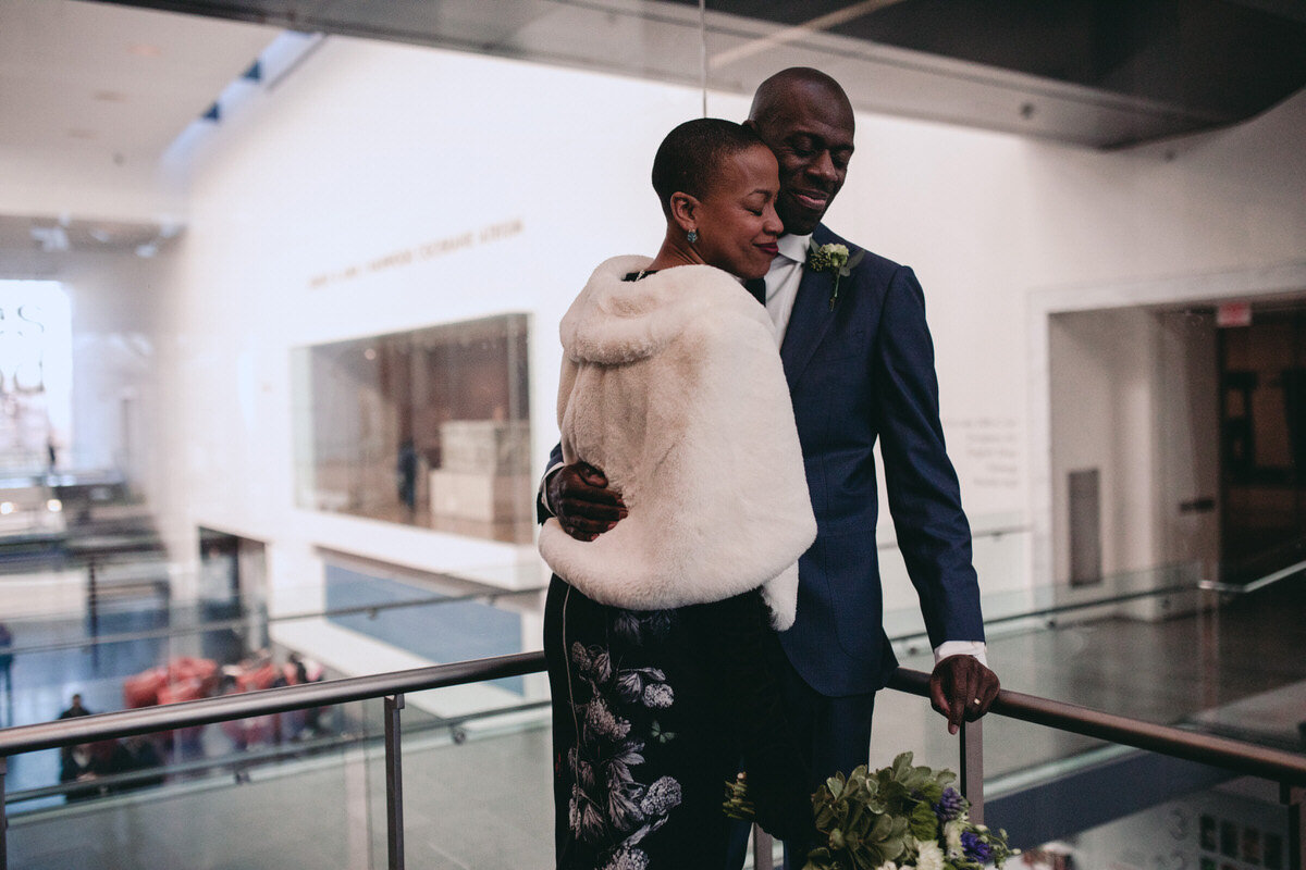  Black couple embracing on wedding day at the Virginia MFA in Richmond, VA, photo by Carly Romeo 