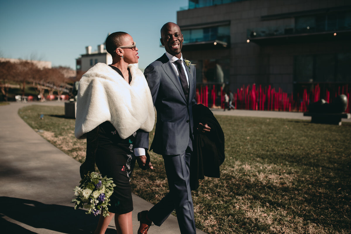  Newlyweds walking in the sun outside at the Virginia MFA in Richmond, VA, Carly Romeo + Co. 