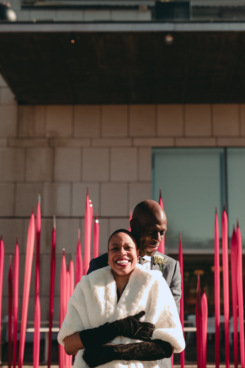 Black newlywed embracing by red sculpture outside the Virginia MFA in Richmond, Carly Romeo &amp; CO. 