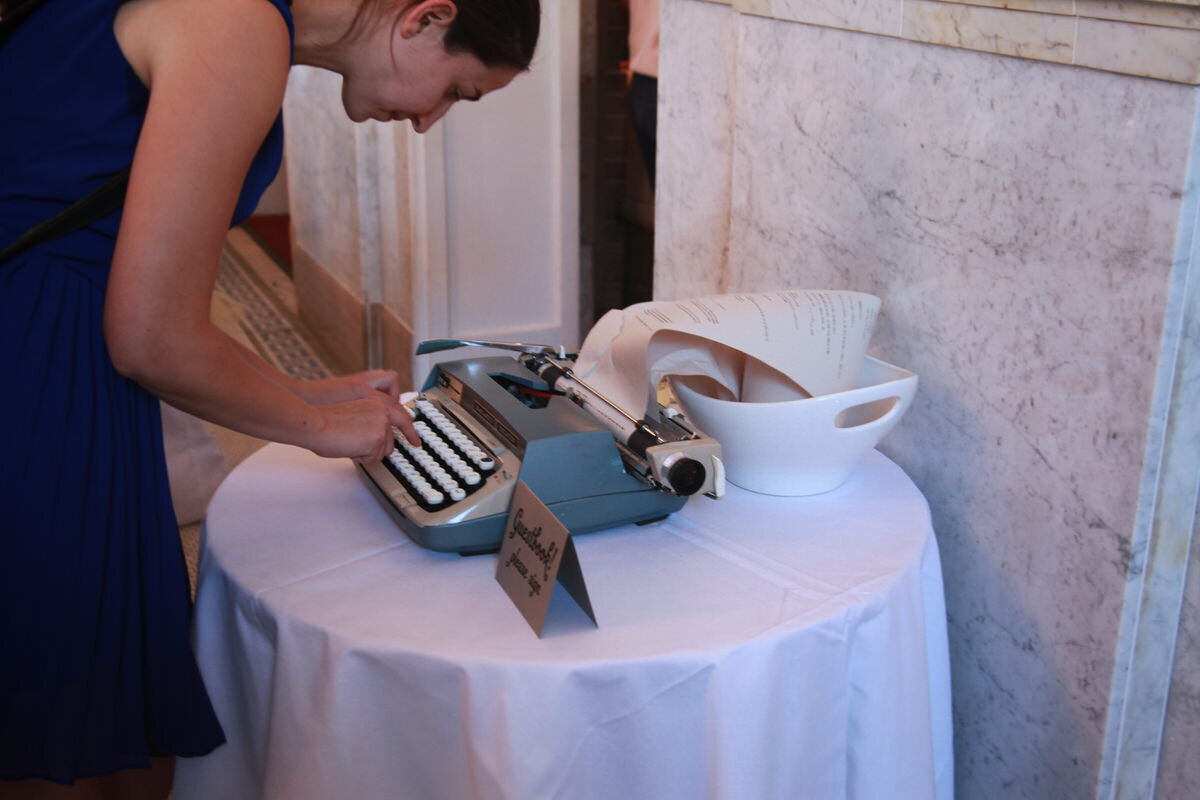 Woman typing on type writer at Wedding Reception in Richmond VA Carly Romeo