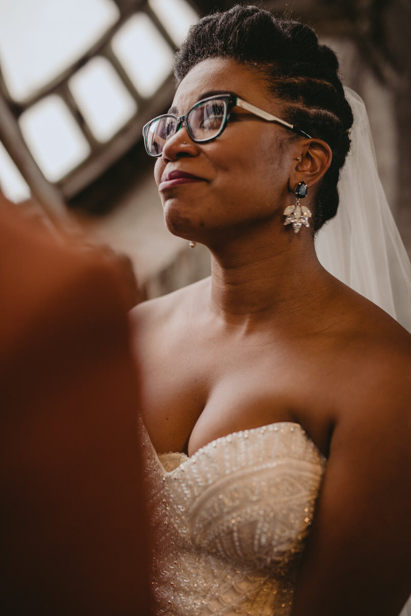 Bride smiling at wedding ceremony in the Bromo Seltzer Arts Tower Baltimore MD Carly Romeo feminist photography