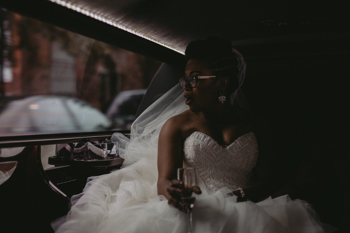 Bride drinking champagne in car after wedding in Baltimore MD Carly Romeo &amp; Co.